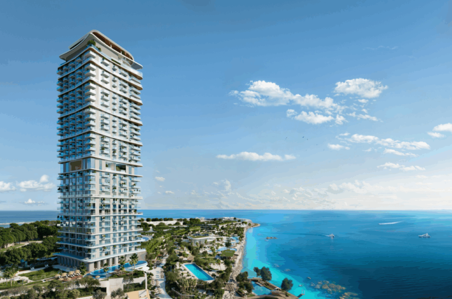 Exterior of Sensia by Beyond featuring a tall, modern skyscraper standing near a coastline, framed by a bright blue sky with scattered clouds. The ocean is calm, with greenery and pools below.