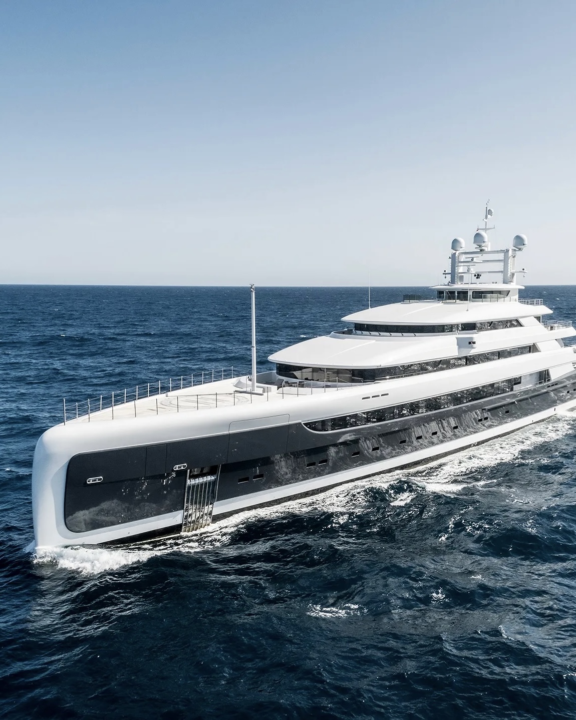 A luxurious yacht sailing through the ocean at speed.