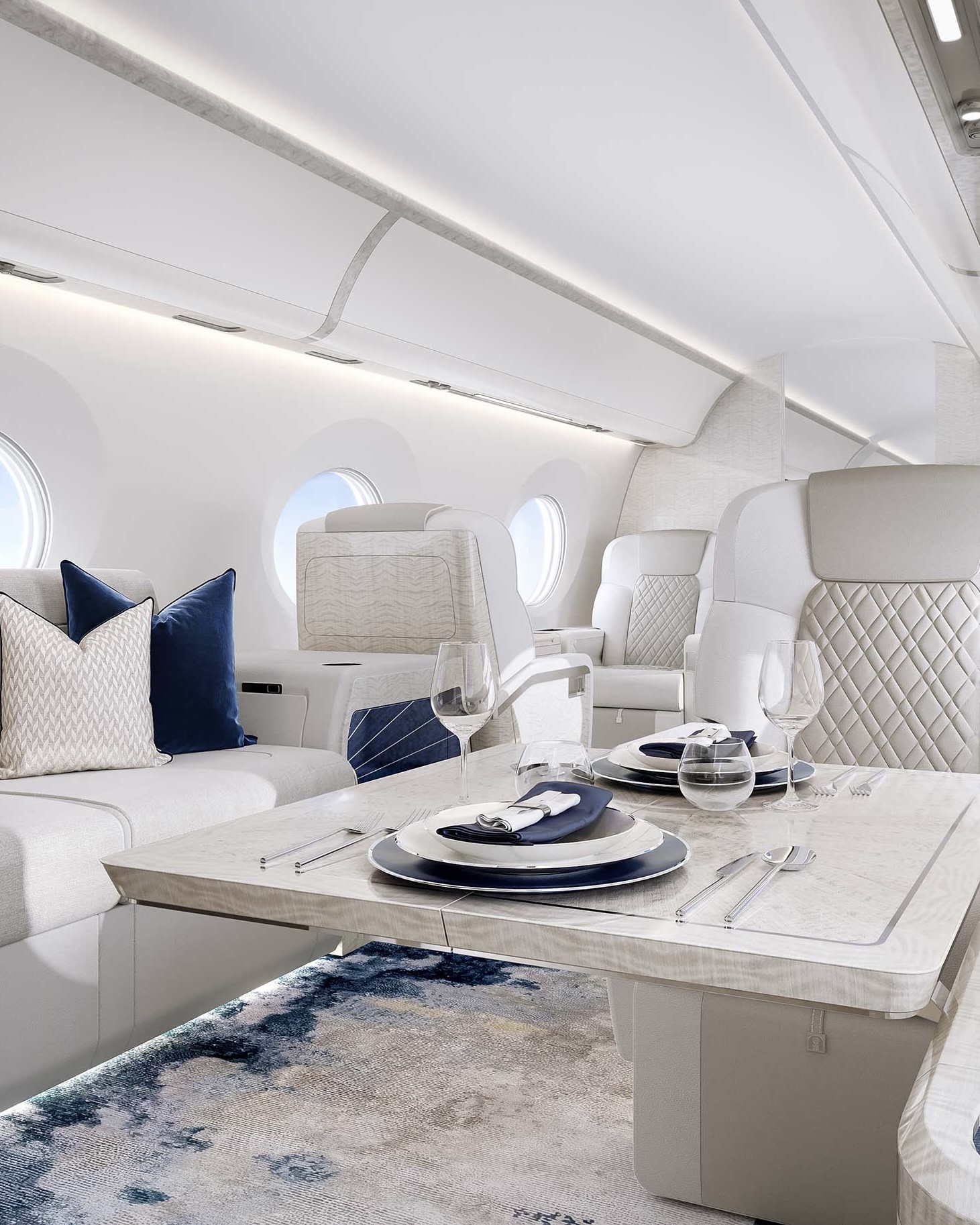 The interior of a private jet, designed in light grey upholstery and blue accents.