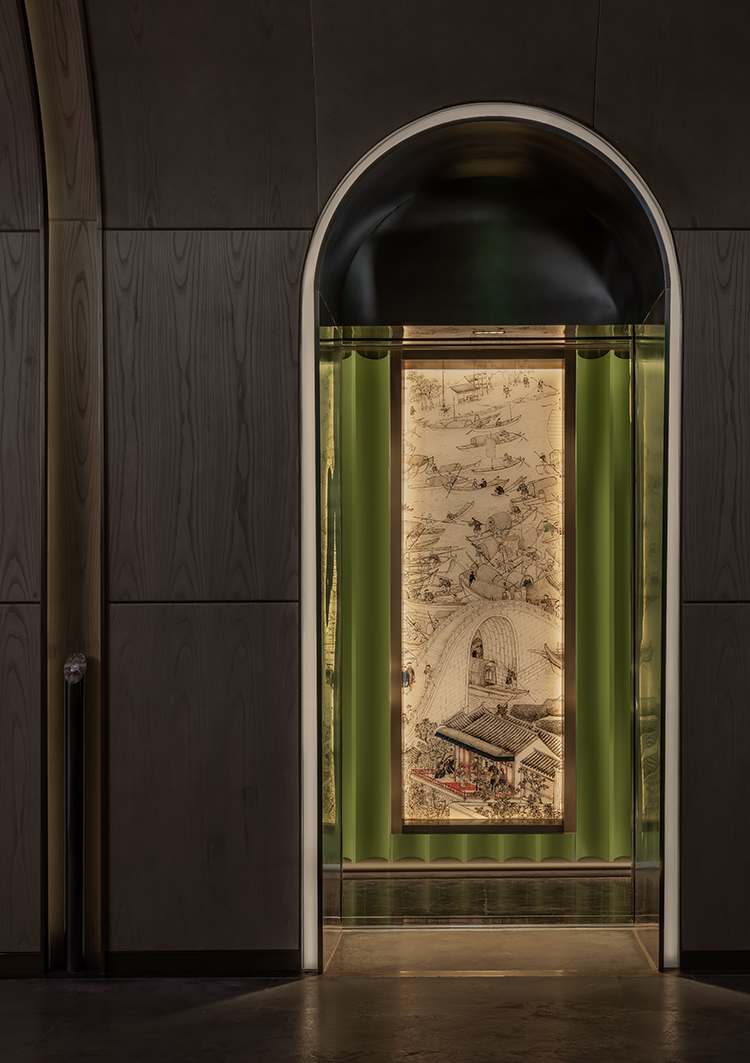 An elegantly framed artwork displayed in a sleek, arched entrance, highlighting intricate details of a traditional scene. The dim lighting and minimalist decor create a sophisticated ambiance.