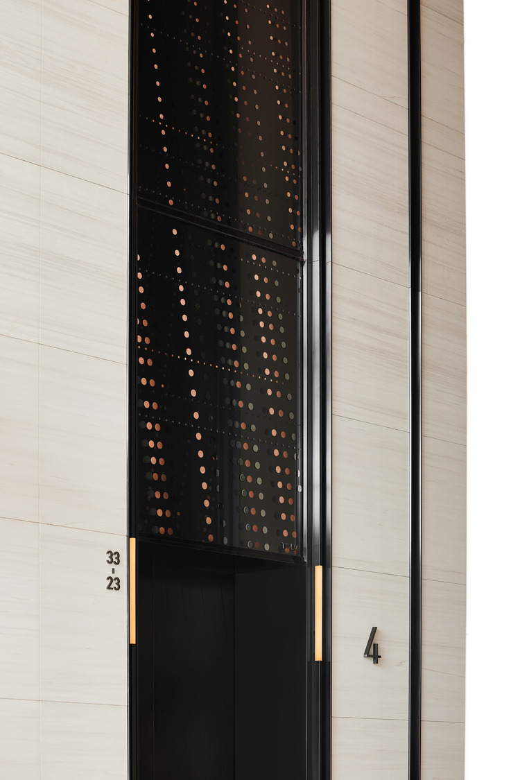 Spacious modern office lobby with geometric ceiling patterns, sleek marble floors, and a minimalist reception desk, conveying a sophisticated and elegant tone.