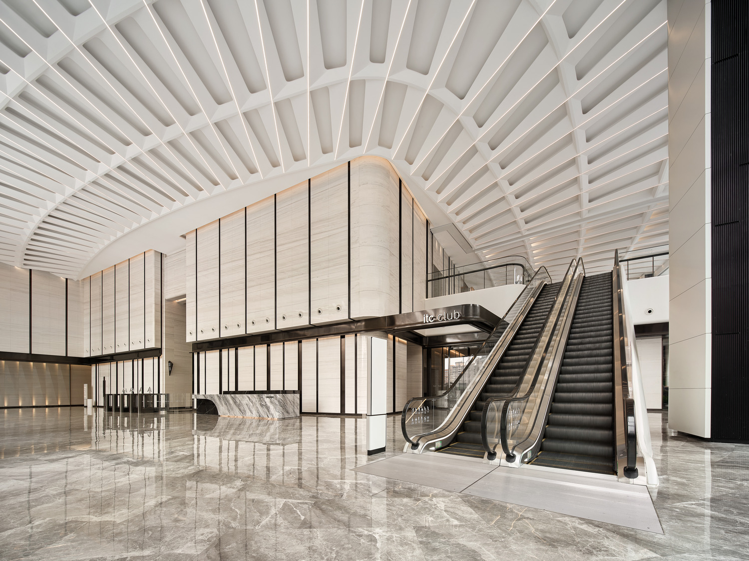 Spacious modern office lobby with geometric ceiling patterns, sleek marble floors, and a minimalist reception desk, conveying a sophisticated and elegant tone.