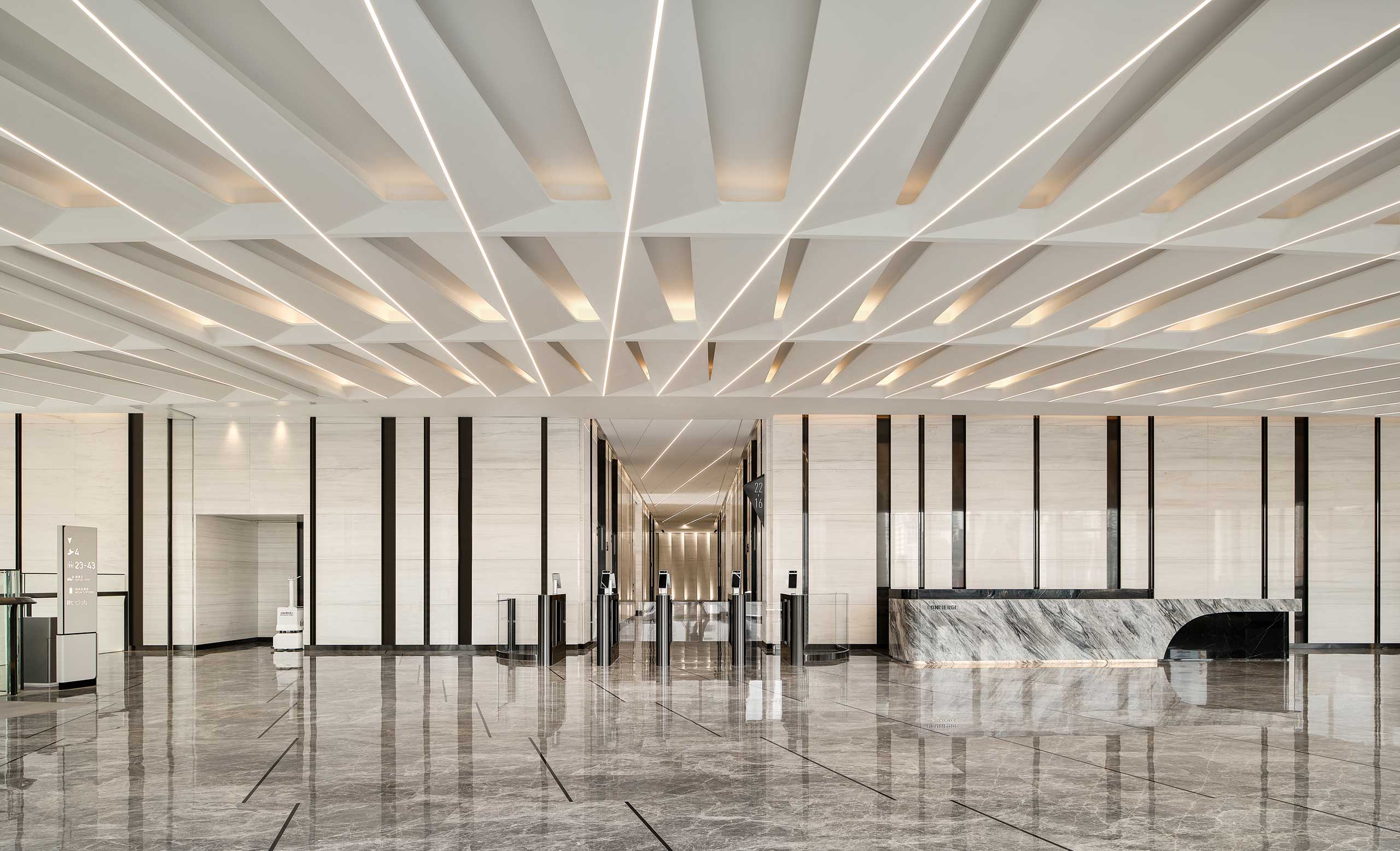 Spacious modern office lobby with geometric ceiling patterns, sleek marble floors, and a minimalist reception desk, conveying a sophisticated and elegant tone.