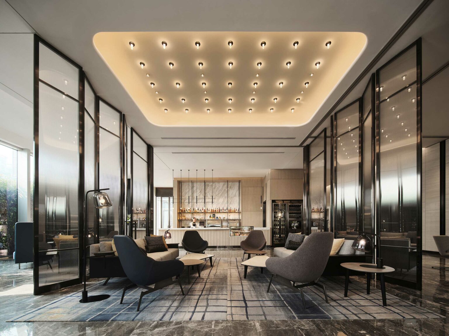 Modern office lounge with elegant chairs and tables, ambient lighting from ceiling fixtures, sleek black panels, soft rugs, and a stylish bar in the background.