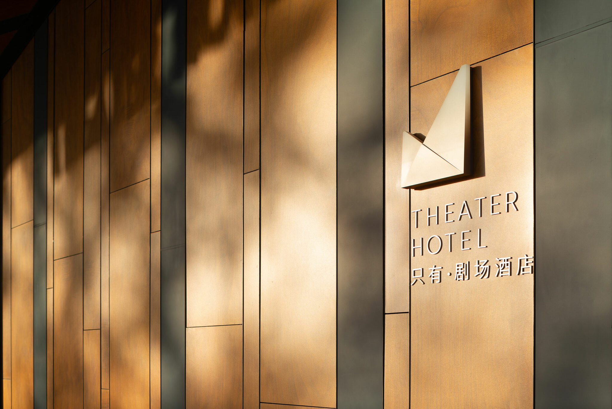 Entrance wall with warm golden panels featuring 