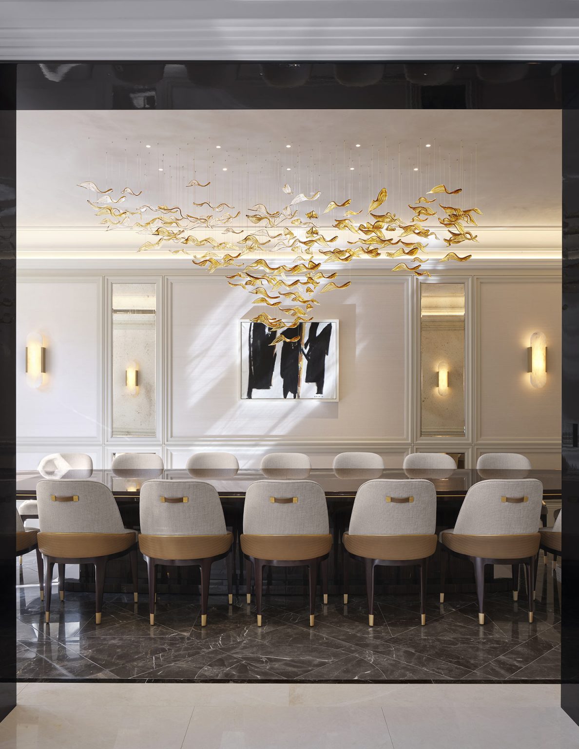 Luxurious dining room with a glossy black oval table surrounded by white chairs. A gold bird-shaped chandelier hangs above. Large windows with beige curtains reveal greenery outside, adding elegance.
