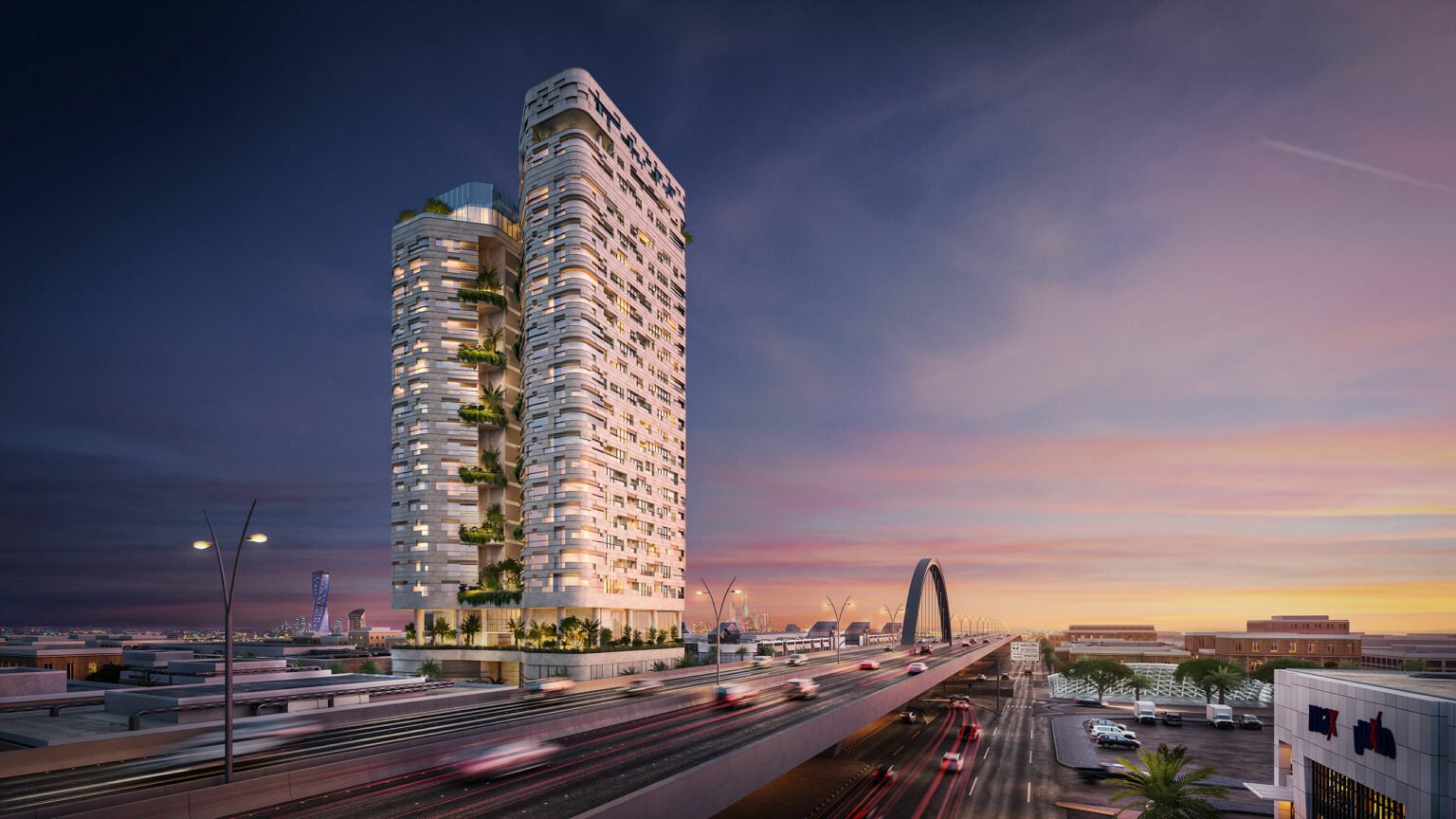 Exterior of AREIC Tower, featuring a modern high-rise building with lush greenery on balconies, adjacent to a busy bridge at sunset. The sky is a gradient of pink and purple hues, creating a tranquil yet vibrant atmosphere.