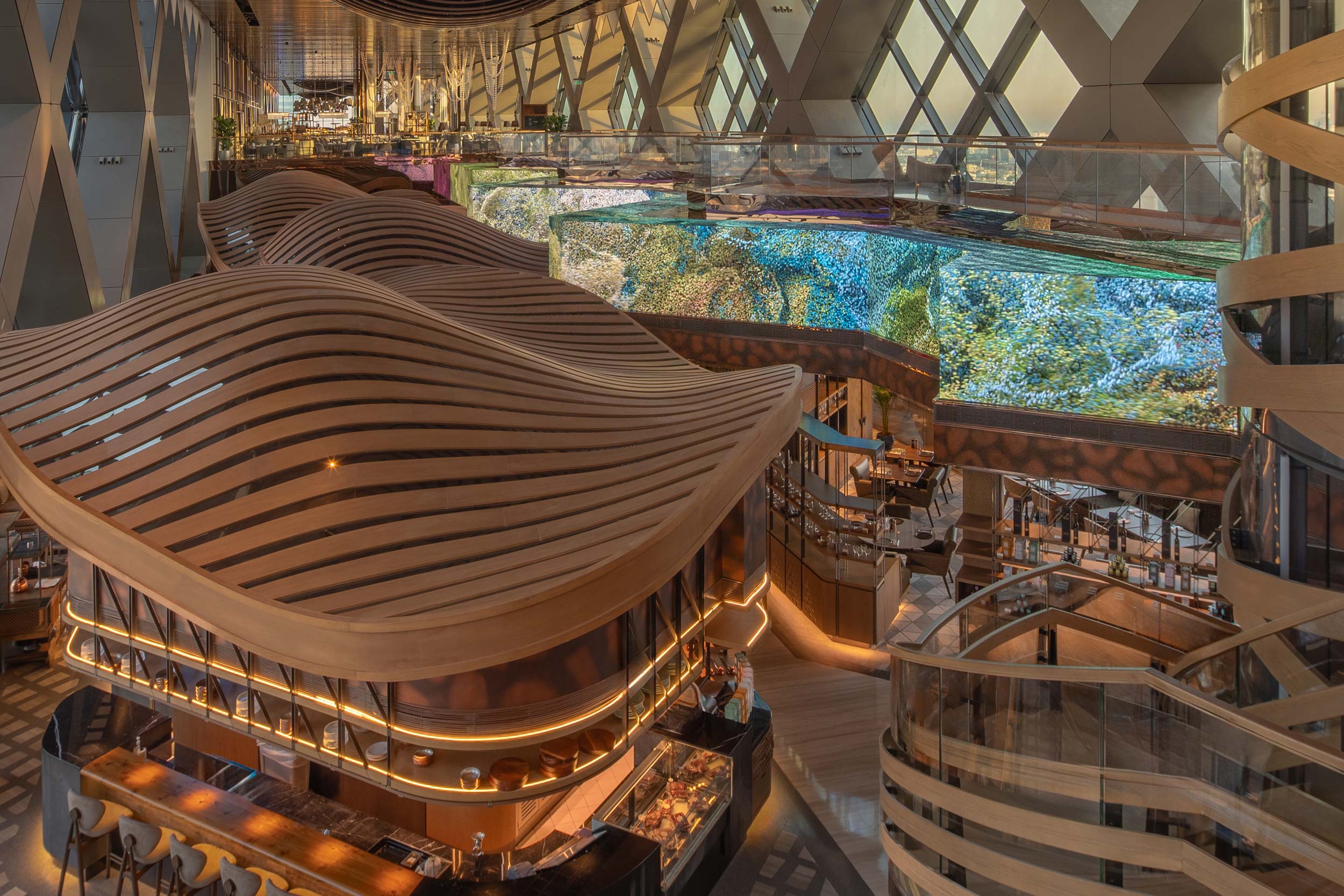 Futuristic food hall interior with curved wooden structures, warm lighting, and digital screens displaying abstract nature images. Luxurious and modern ambiance.