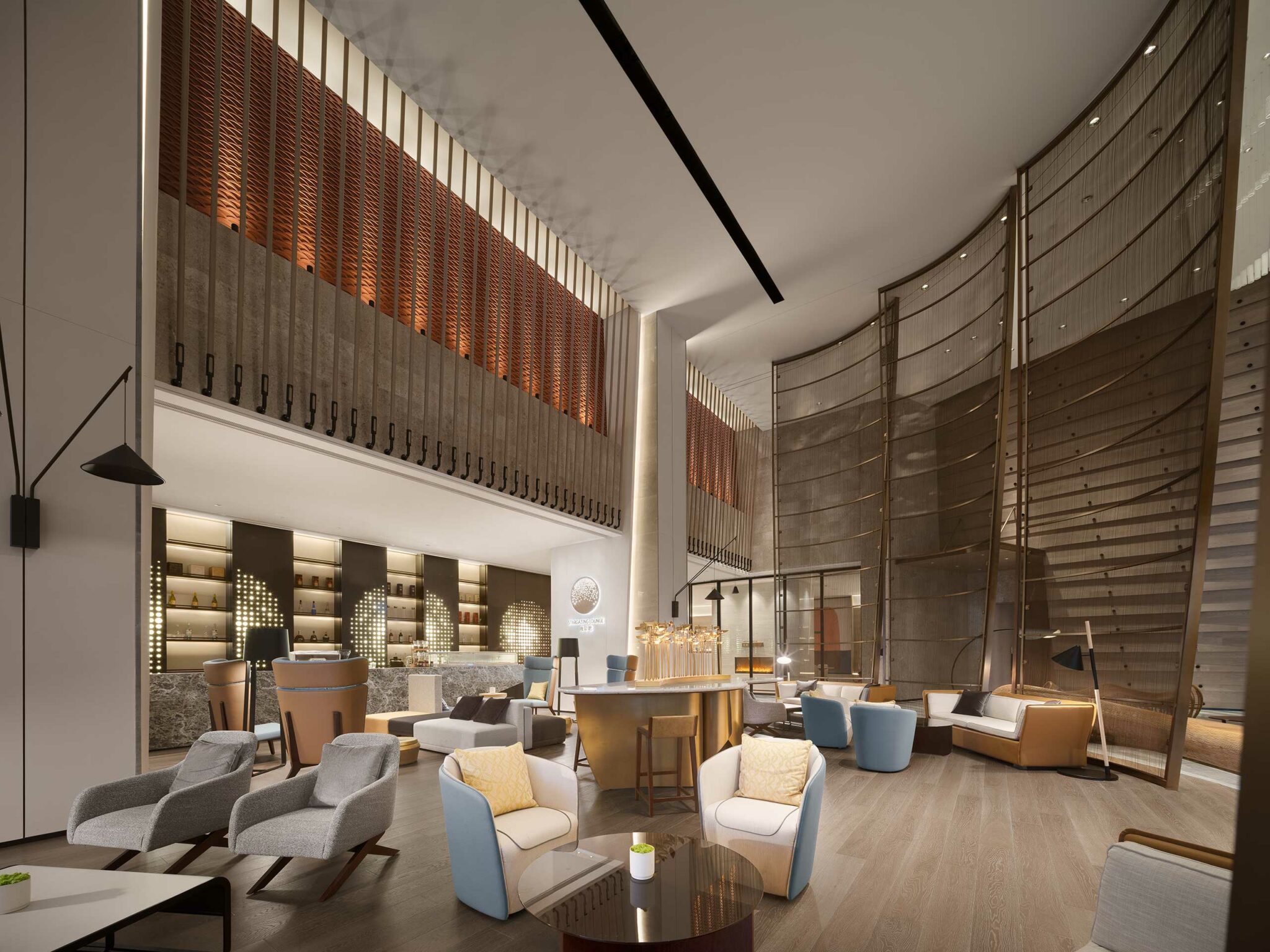 Luxurious hotel lobby with modern seating, warm lighting, and textured walls. Features elegant furniture, a cozy atmosphere, and minimalist decor.