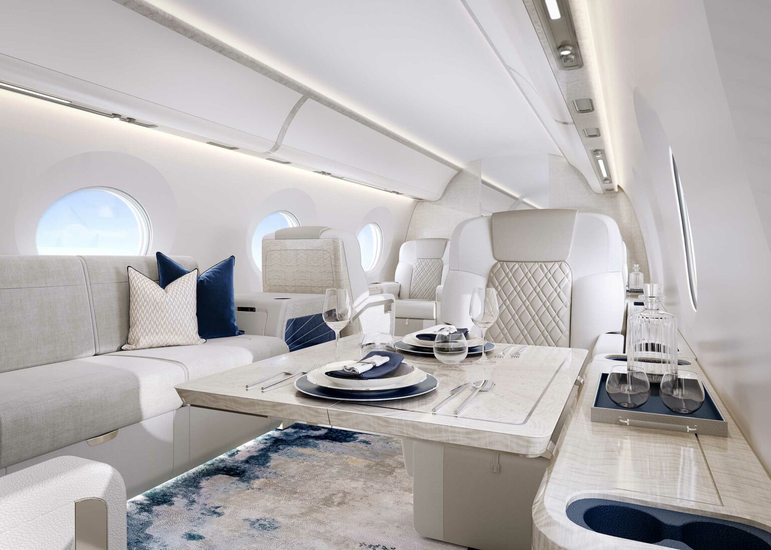 The interior of a private jet, designed in light grey upholstery and blue accents.