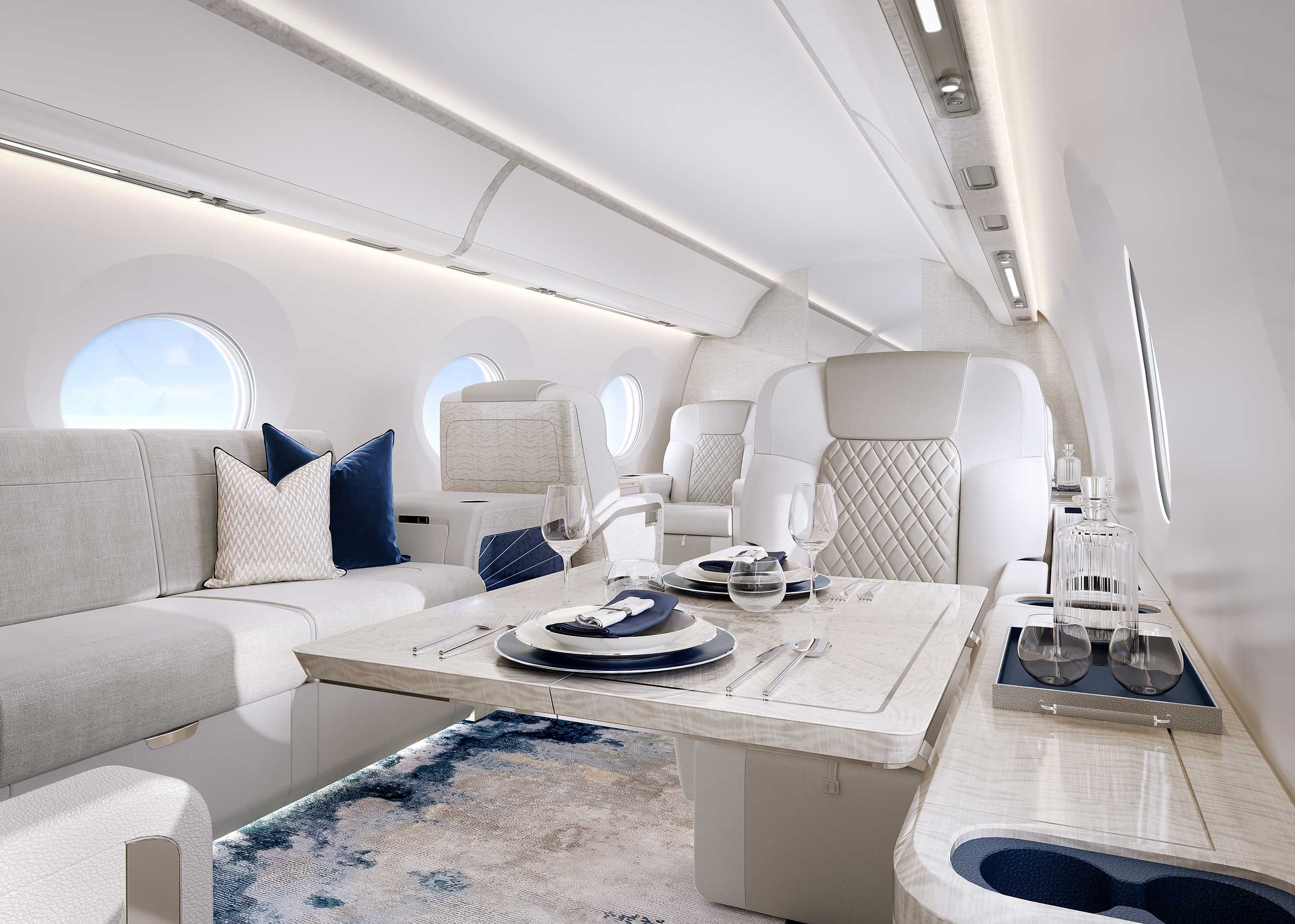 The interior of a private jet, designed in light grey upholstery and blue accents.
