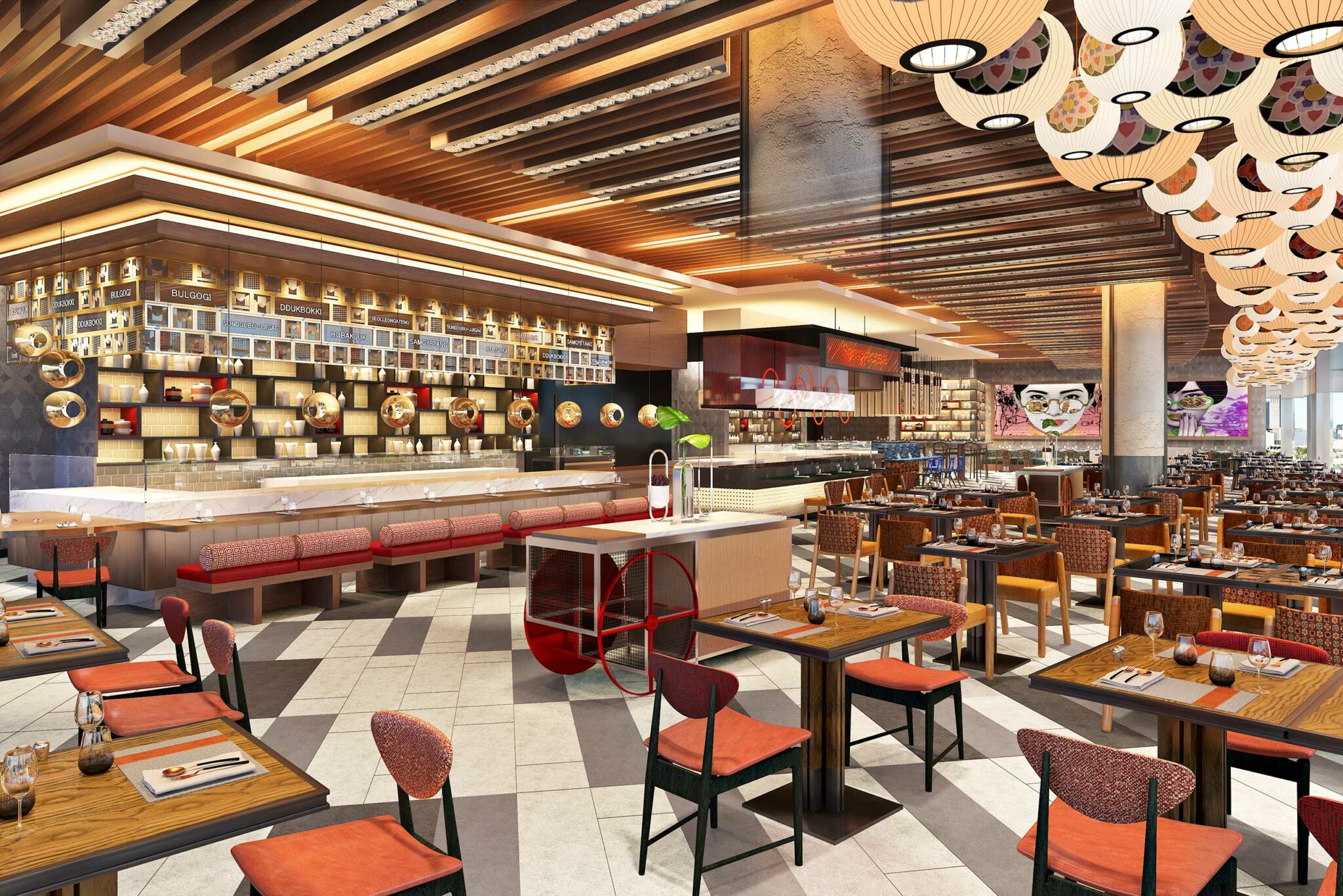 Modern hotel restaurant interior with warm lighting and wooden accents. Features red cushioned seating, decorative ceiling lights, and colorful wall art.