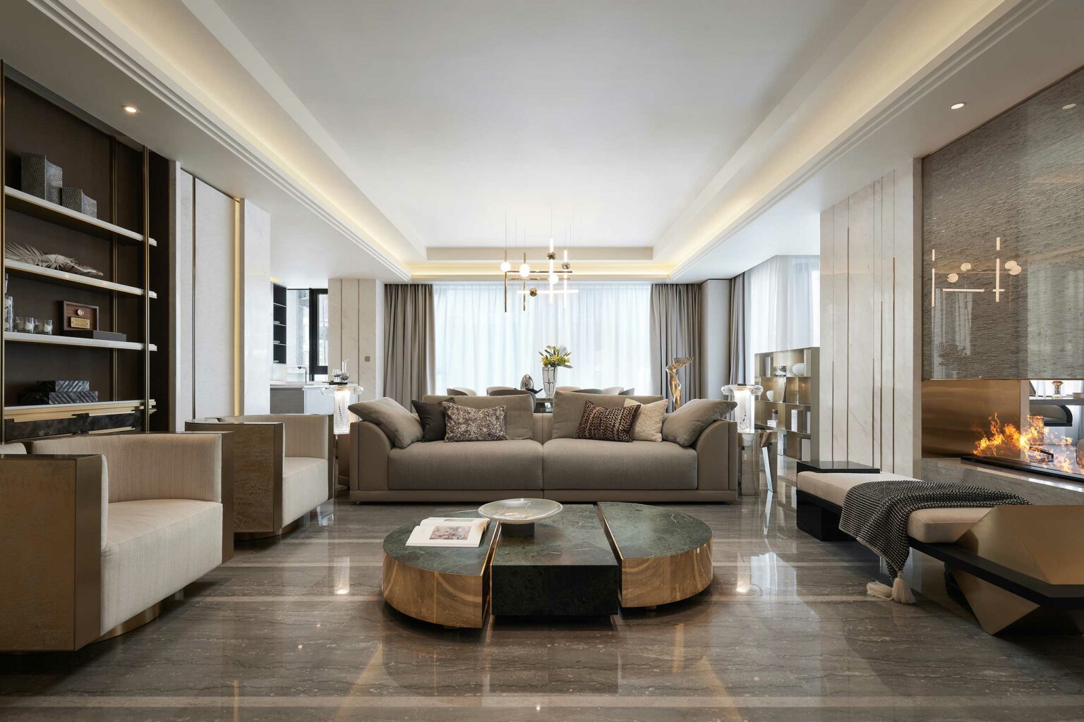 Luxurious living room featuring a modern gray sofa with patterned cushions, a sleek black and gold coffee table, and a cozy fireplace; elegant ambiance.
