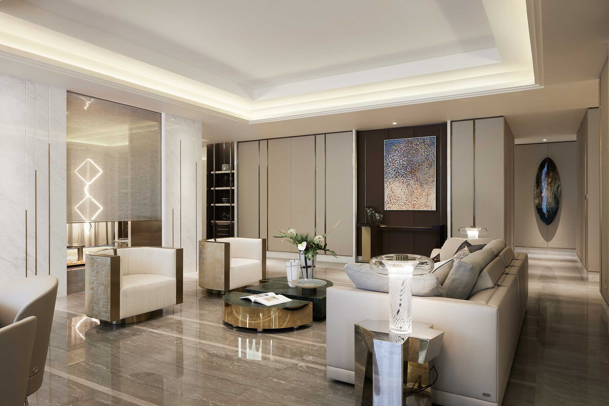A luxurious living room with modern decor, featuring beige walls, a plush sectional sofa, elegant armchairs, and a round coffee table. The lighting is soft, enhancing the tranquil atmosphere.