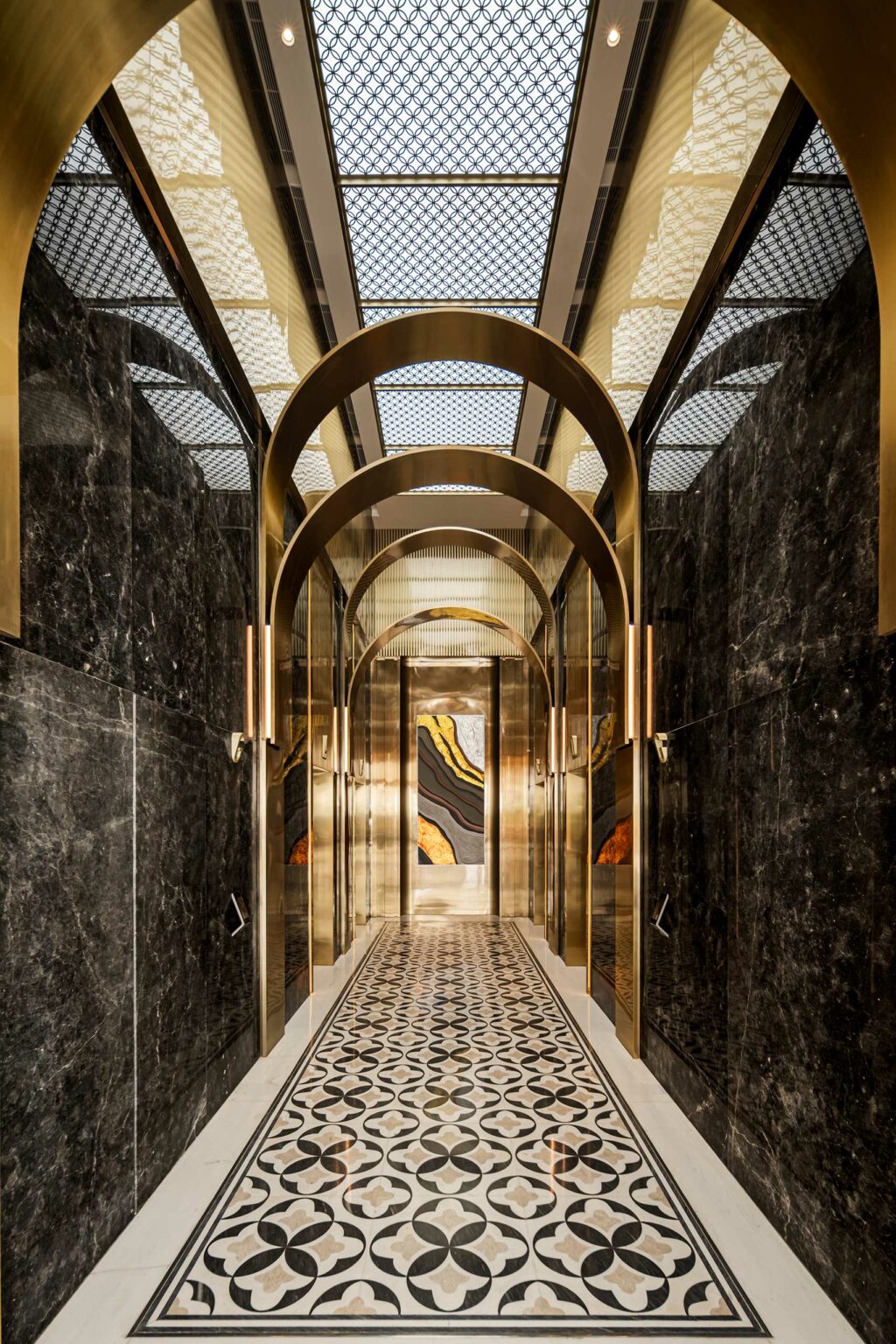 Luxurious office hallway with dark marble walls and patterned floor, featuring gold arches and a geometric ceiling, leading to an artistic mural.