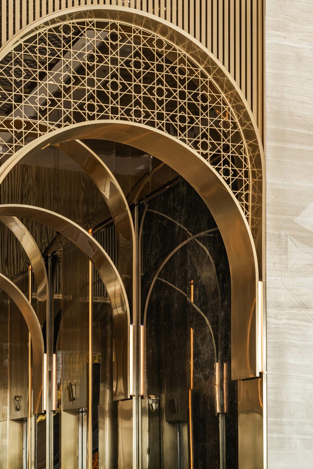 Elegant golden arches with intricate geometric patterns create a luxurious office ambiance. Reflections on glossy surfaces enhance the opulent atmosphere.