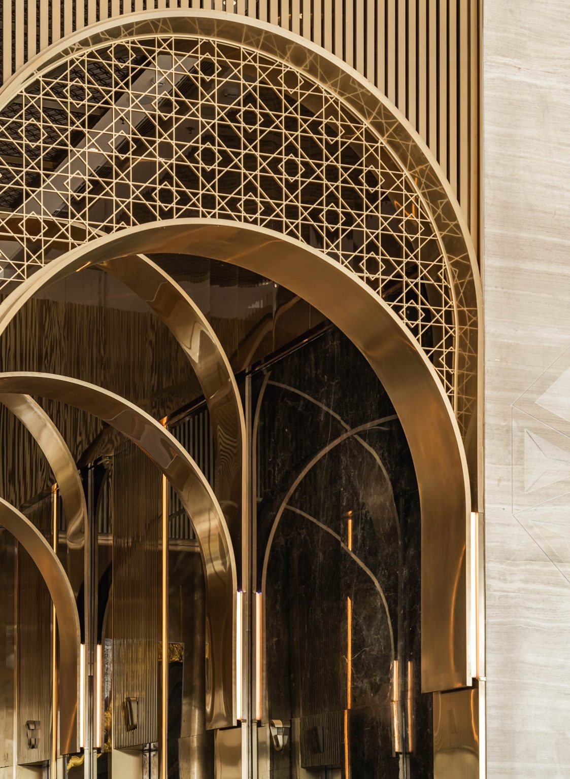Elegant golden arches with intricate geometric patterns create a luxurious office ambiance. Reflections on glossy surfaces enhance the opulent atmosphere.