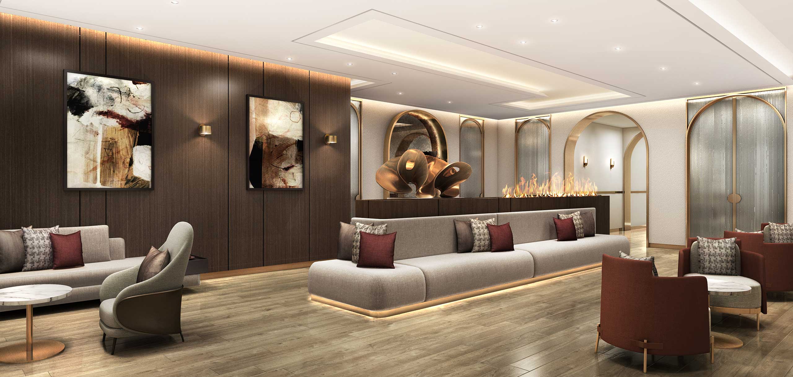 A modern, elegant residential lounge with a long beige sofa adorned with red and gray pillows. Abstract art decorates dark wood walls. Sculptures sit on a shelf above a subtle fireplace, adding warmth and sophistication.