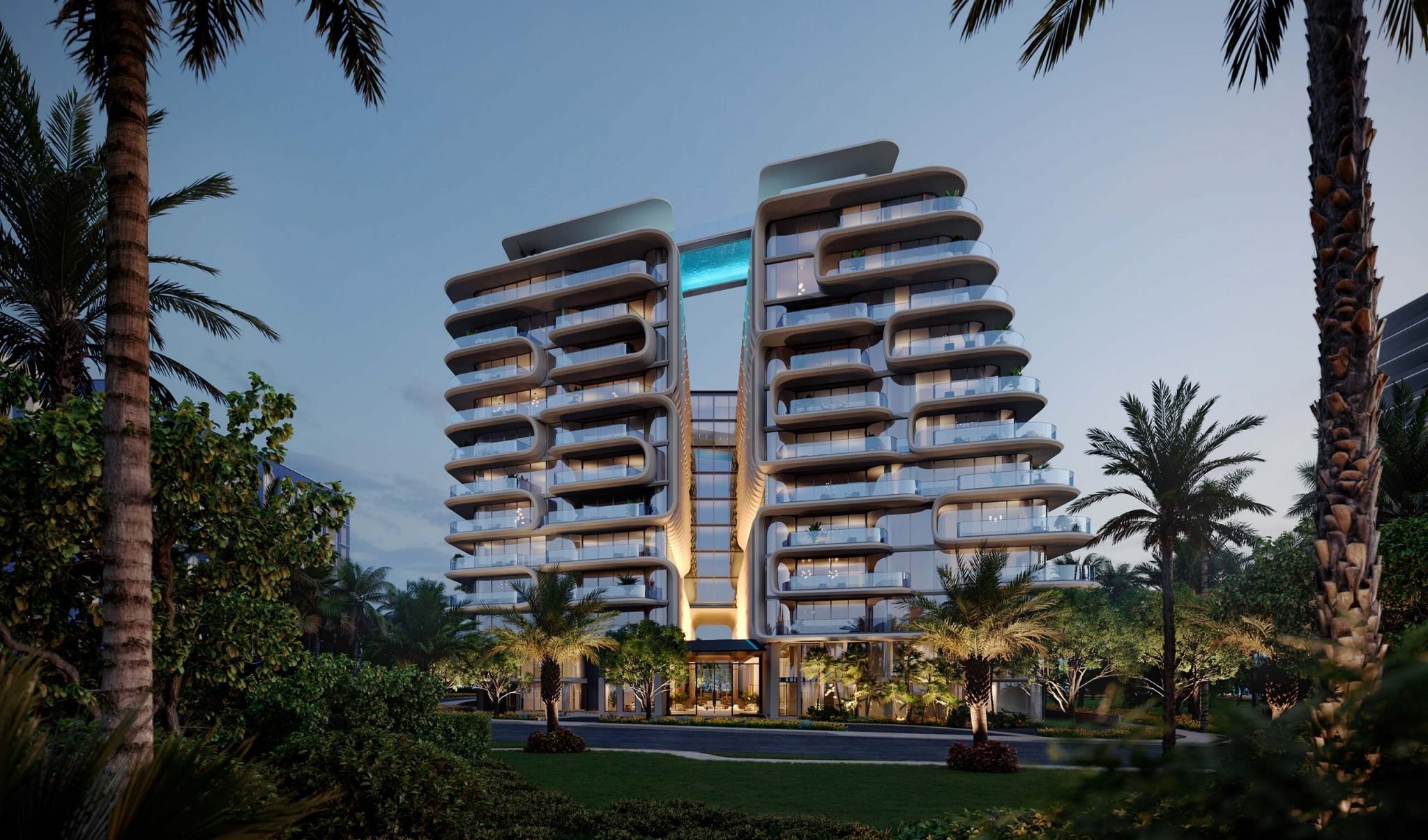 Exterior of Surfside Miami featuring a modern luxury apartment building at dusk defined by a symmetrical design with curved balconies, ambient lighting, and surrounded by palm trees.