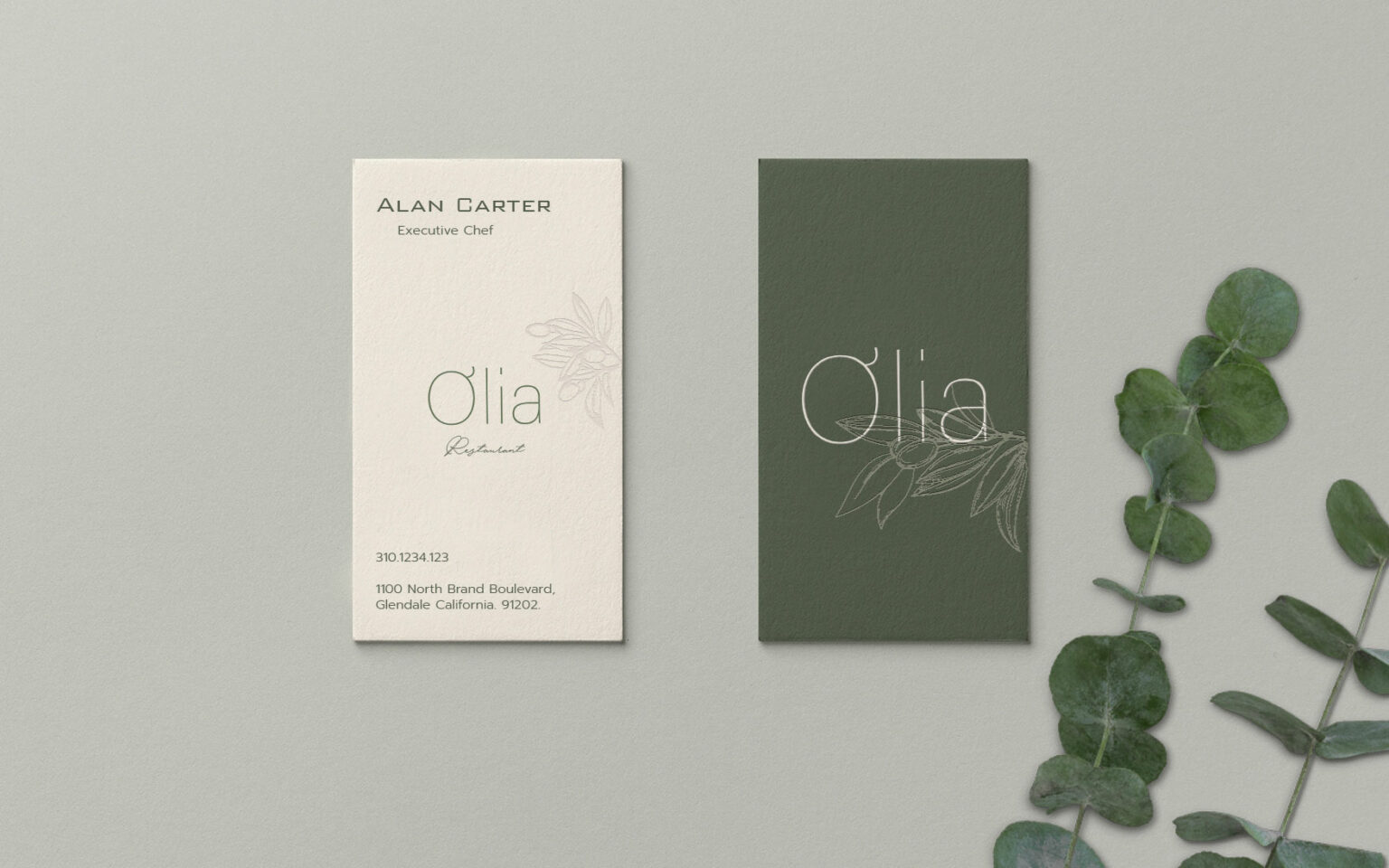 Olia Restaurant branding collaterals, featuring two elegant business cards. The left card is cream-colored with text: 