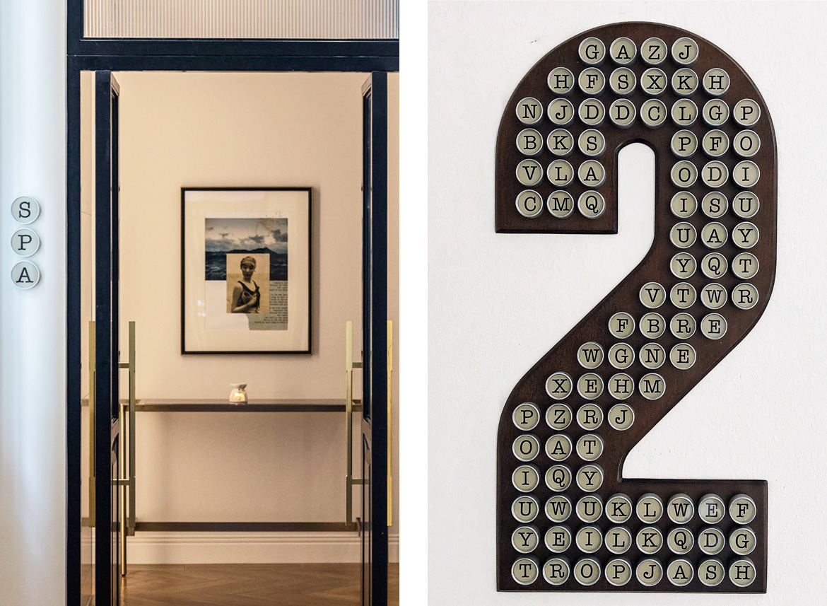 A hotel spa entrance with a minimalist design features a candlelit table and framed art. On the right, a large, decorative 