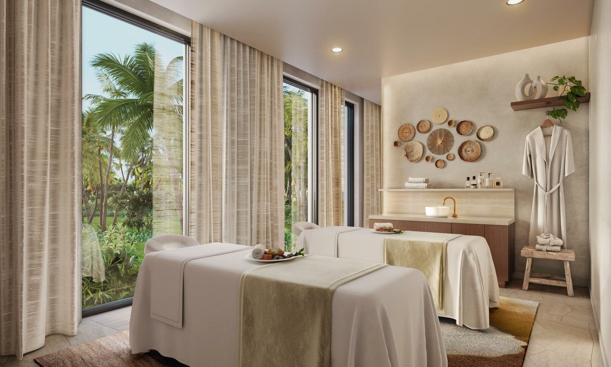 A serene home spa treatment room with two massage beds adorned with beige linens, large windows showing tropical greenery, and calming decor on the walls.