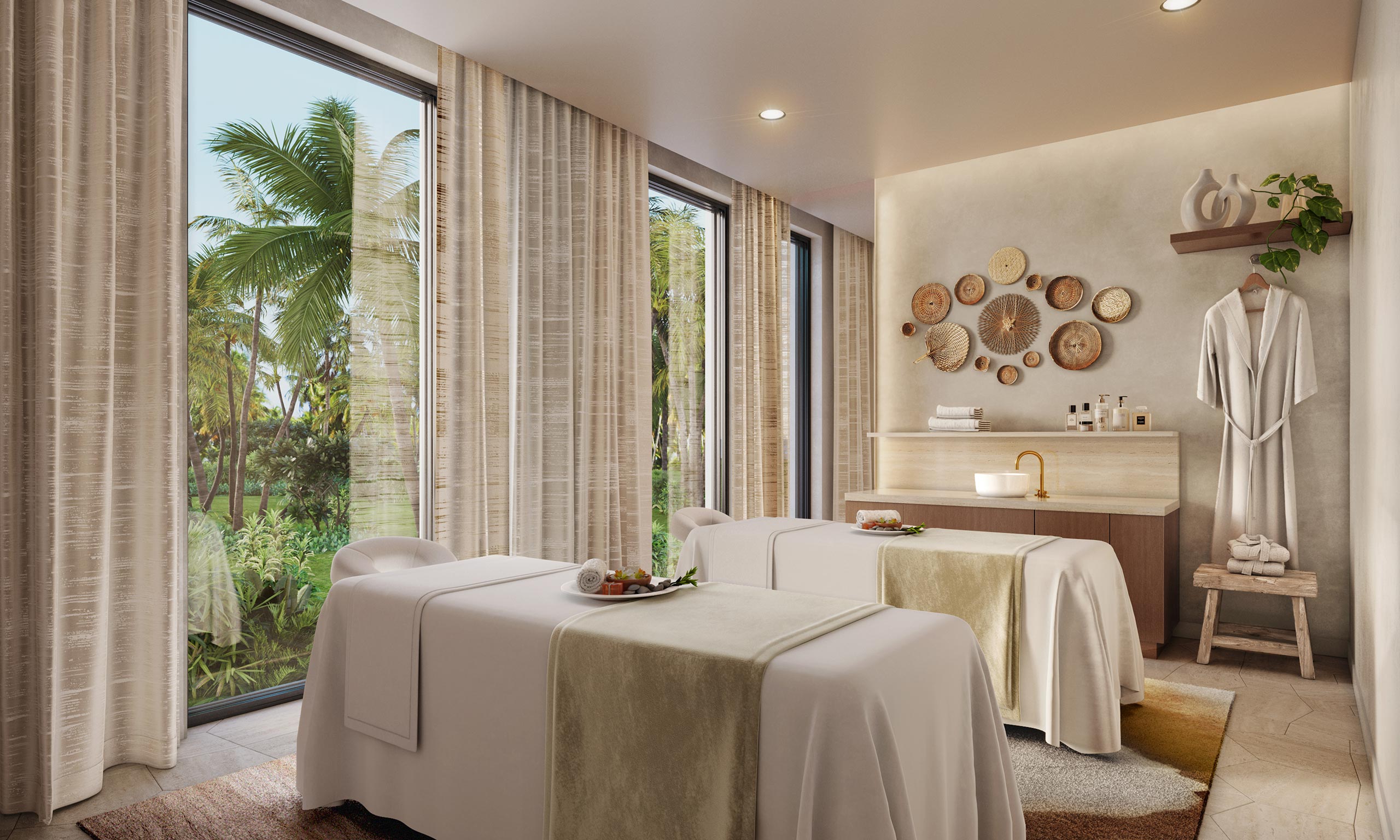 A serene home spa treatment room with two massage beds adorned with beige linens, large windows showing tropical greenery, and calming decor on the walls.