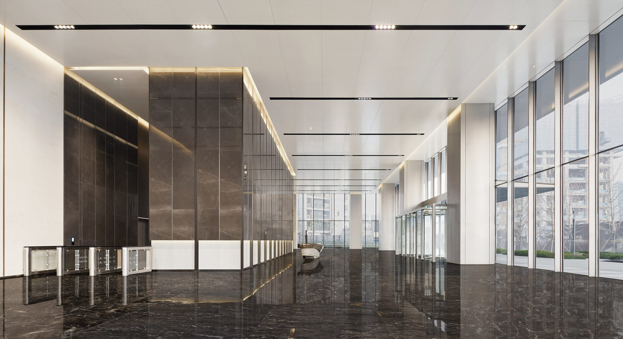 Spacious, modern office lobby with glossy black marble floor, tall windows, and minimalist design. Warm ambient lighting creates an elegant, professional atmosphere.