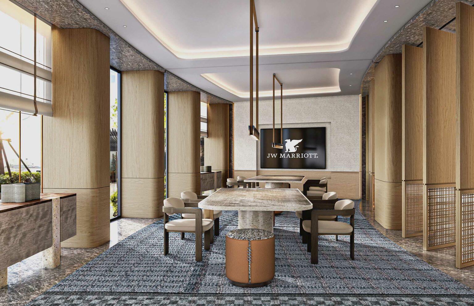 Elegant board room with a modern design, featuring wooden pillars, stylish seating around a stone table, and soft lighting. JW Marriott logo displayed.
