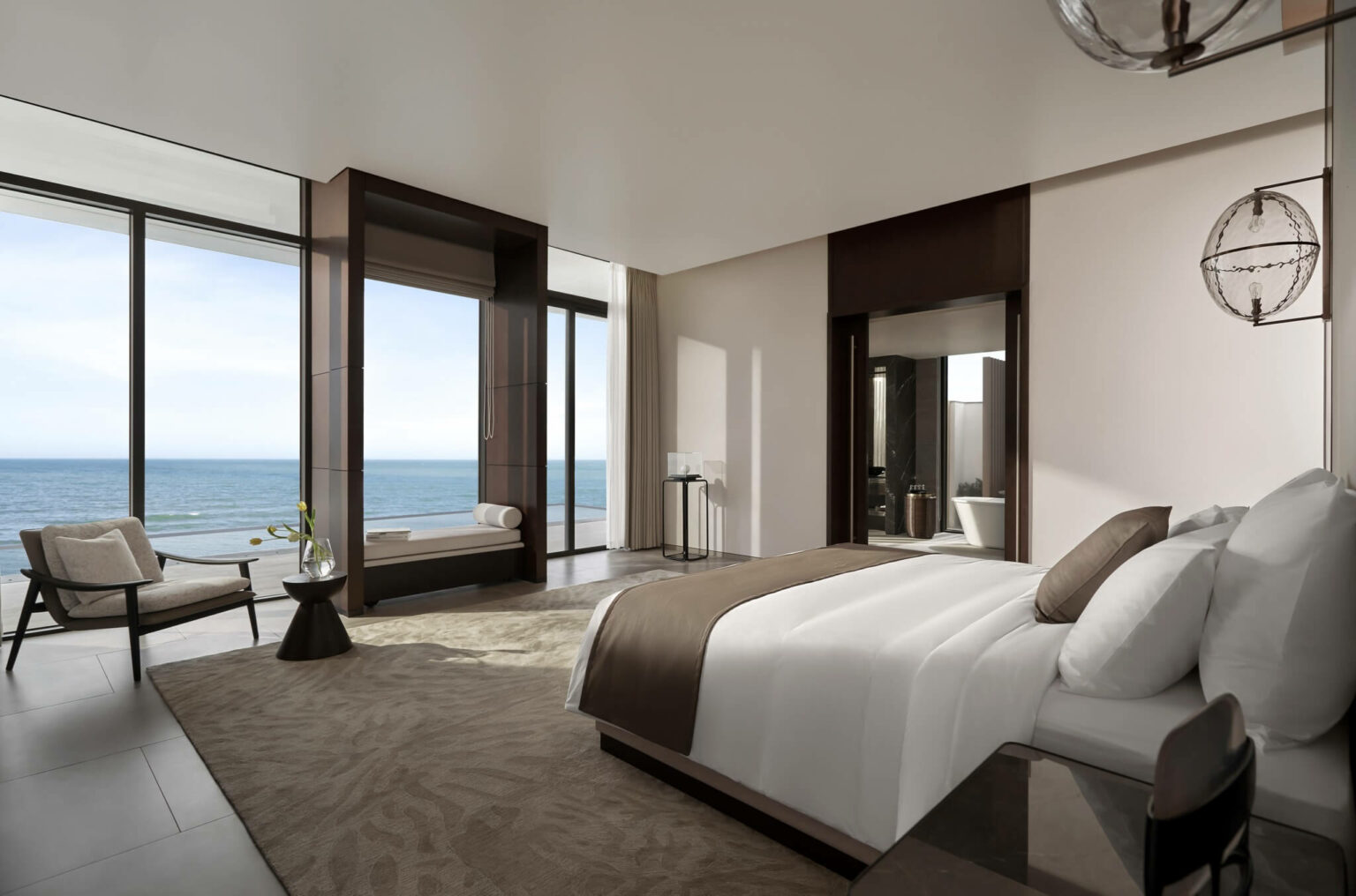 Luxurious hotel bedroom with ocean view, featuring a plush bed, elegant decor, and floor-to-ceiling windows. The tone is serene and sophisticated.