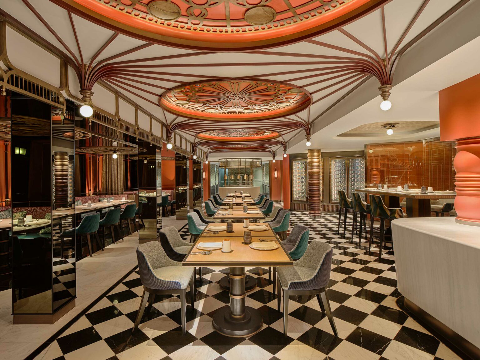 Luxurious restaurant interior with ornate red and white ceiling, geometric patterns, elegant lighting, checkered floor, and neatly set tables, creating a sophisticated ambiance.