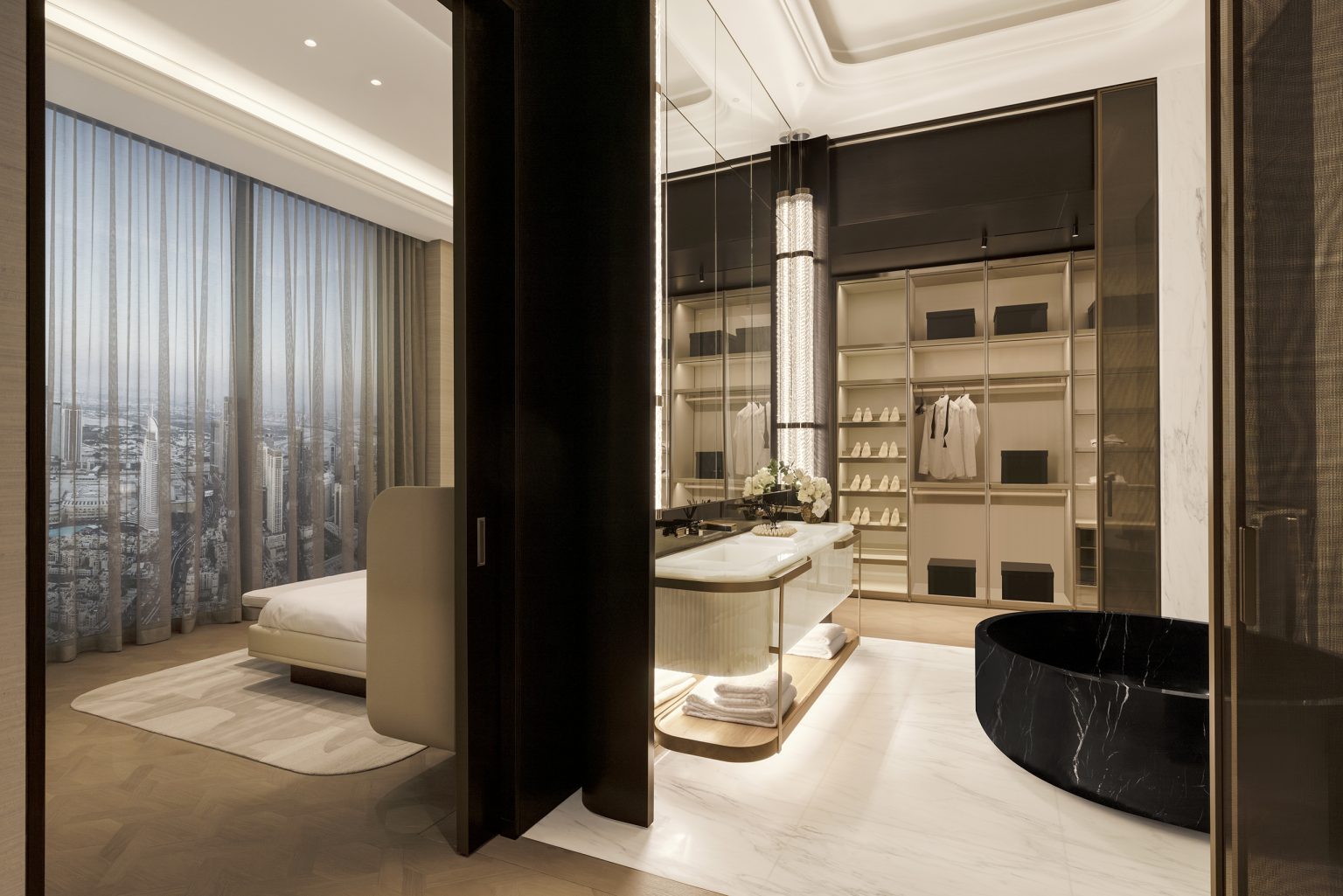 Luxurious walk-in closet with dark wood, elegant lighting, a marble sink, and a large window. Sophisticated and opulent.