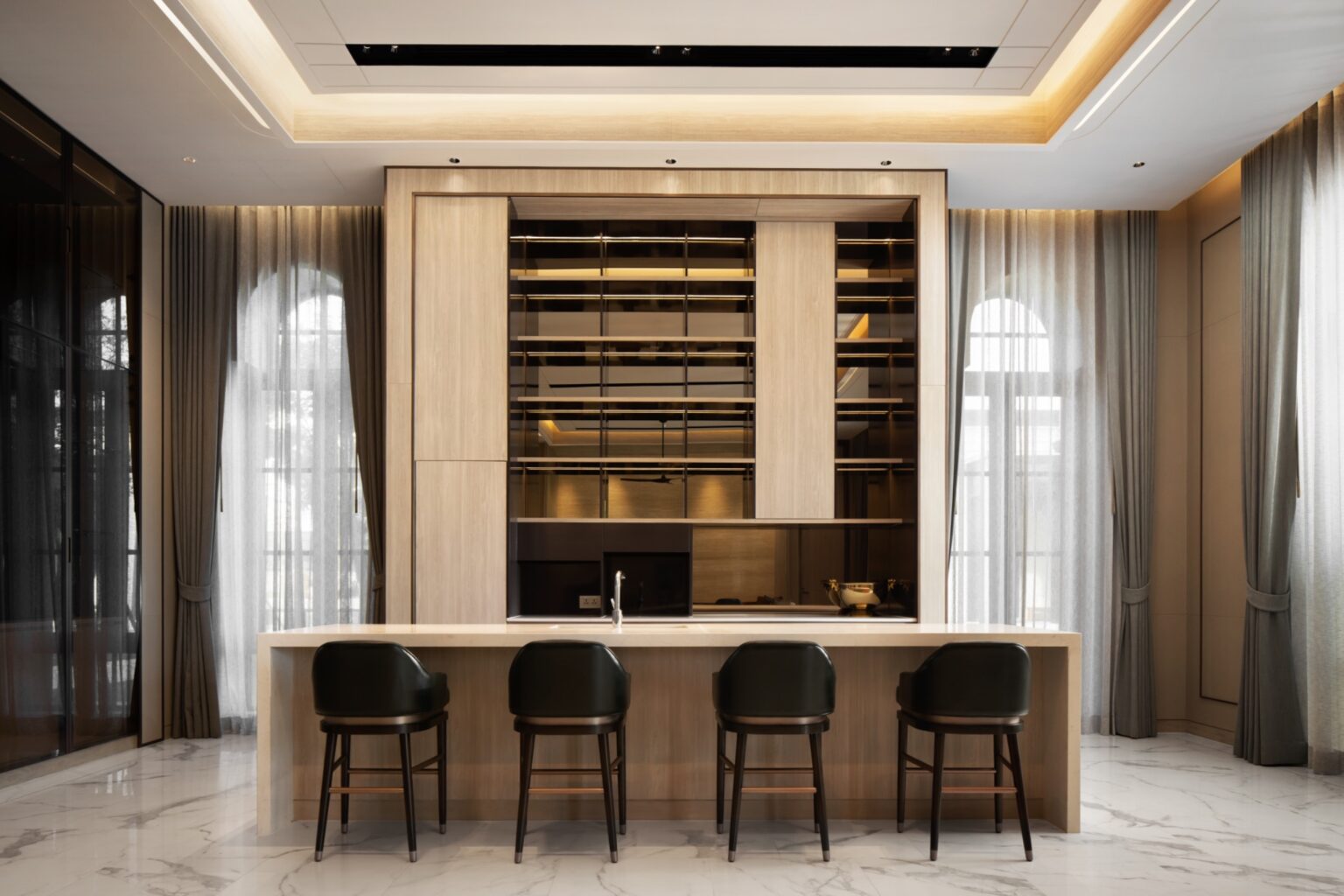 Luxurious modern kitchen features a large island with four dark chairs, sleek wooden cabinetry, and floor-to-ceiling windows with sheer curtains, exuding elegance.