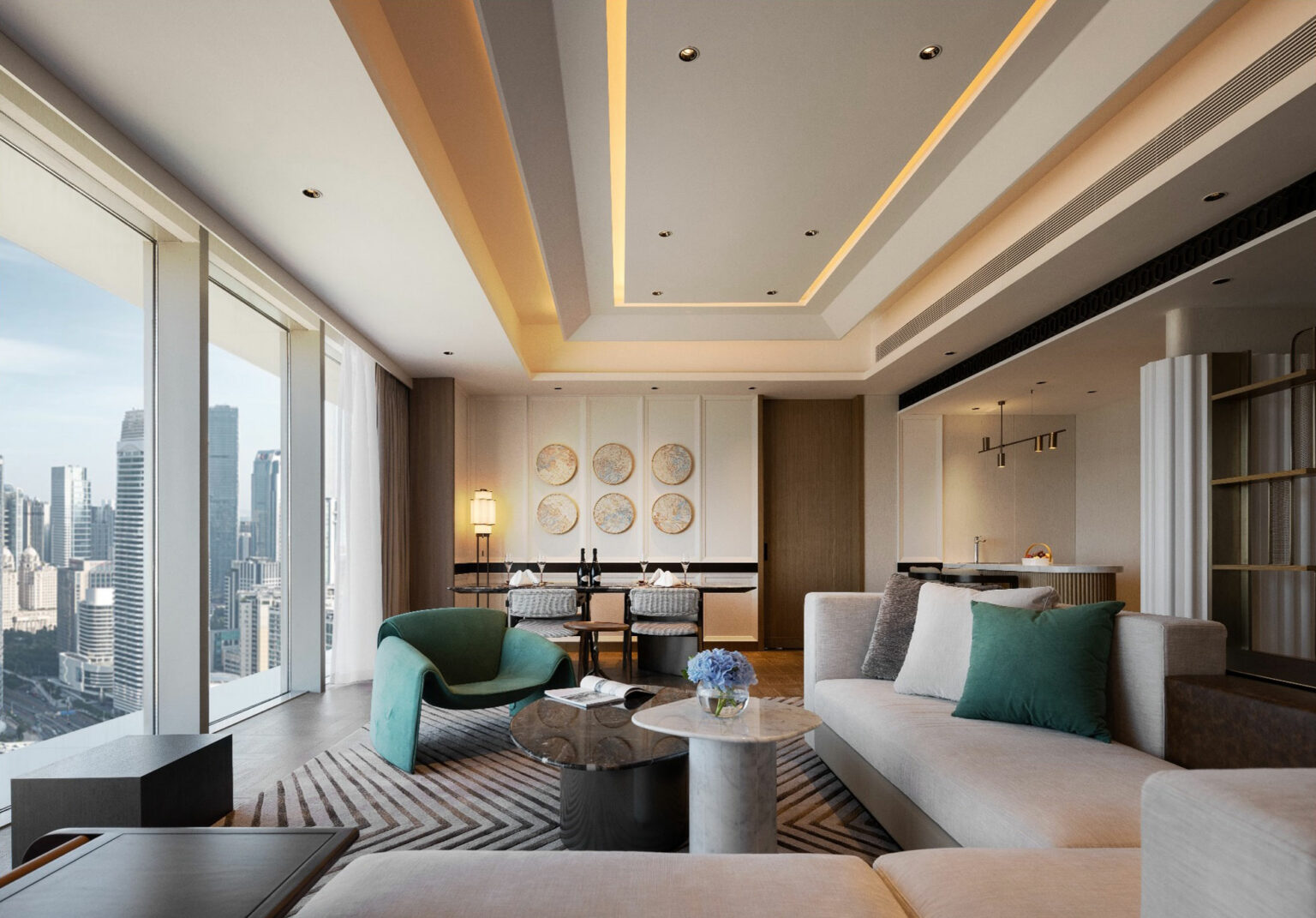 Spacious modern suite living room with large windows showcasing city skyline. Features plush seating, round coffee table, artistic wall decor, and soft lighting.