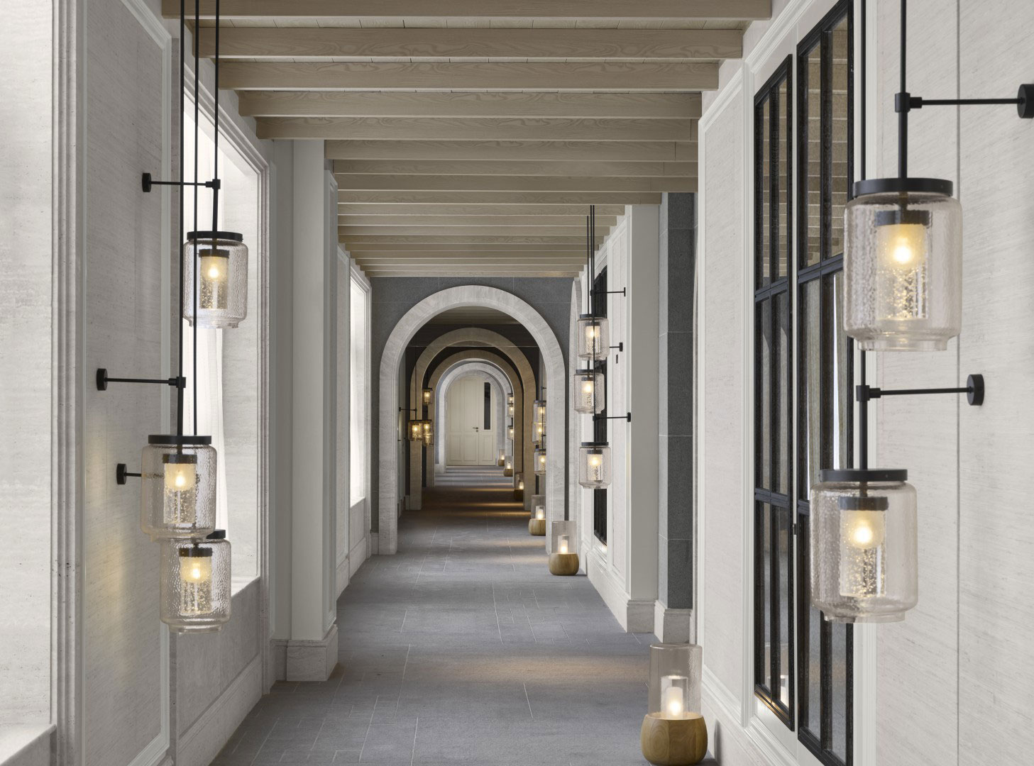 Elegant hotel hallway with modern light fixtures and arched doorways, creating a serene atmosphere. Soft lighting and neutral tones convey tranquility.