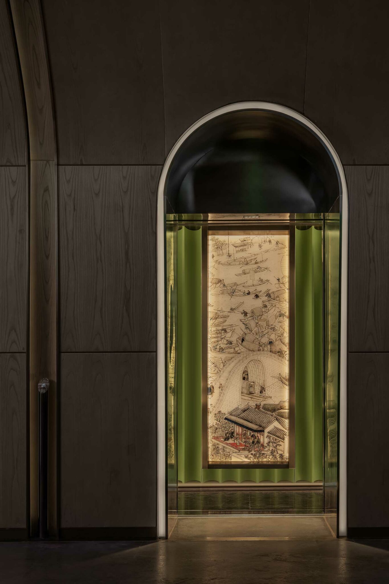 A warmly lit, ornate scroll with intricate traditional illustrations hangs inside an arched dark doorway, framed by glowing green accents, creating a serene and elegant atmosphere.