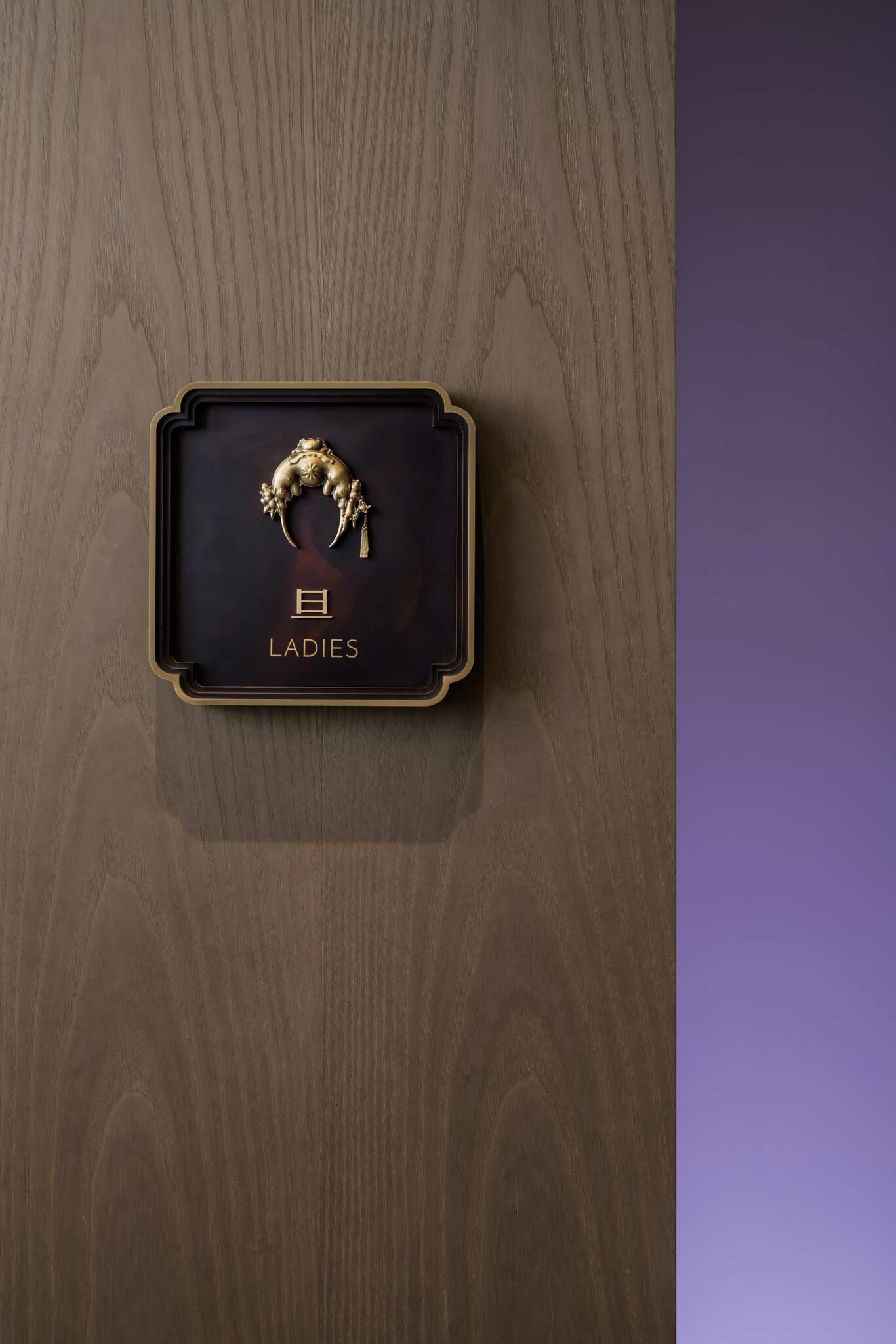 Square sign on a wooden wall, labeled 