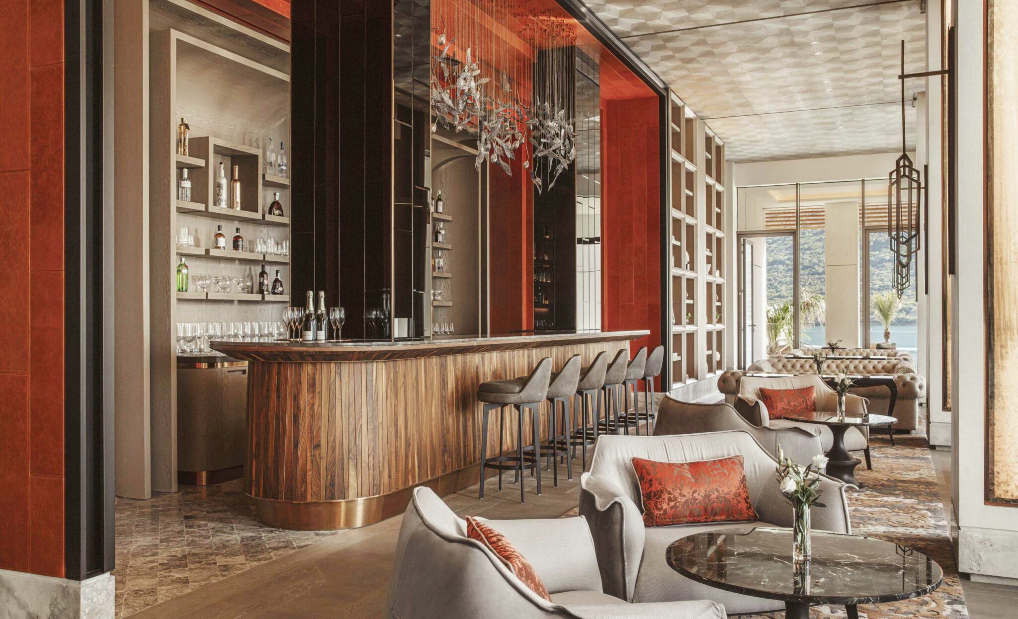 Sophisticated lounge bar with a wooden counter, stylish barstools, and elegant decor. Luxurious seating area with plush chairs and warm lighting.