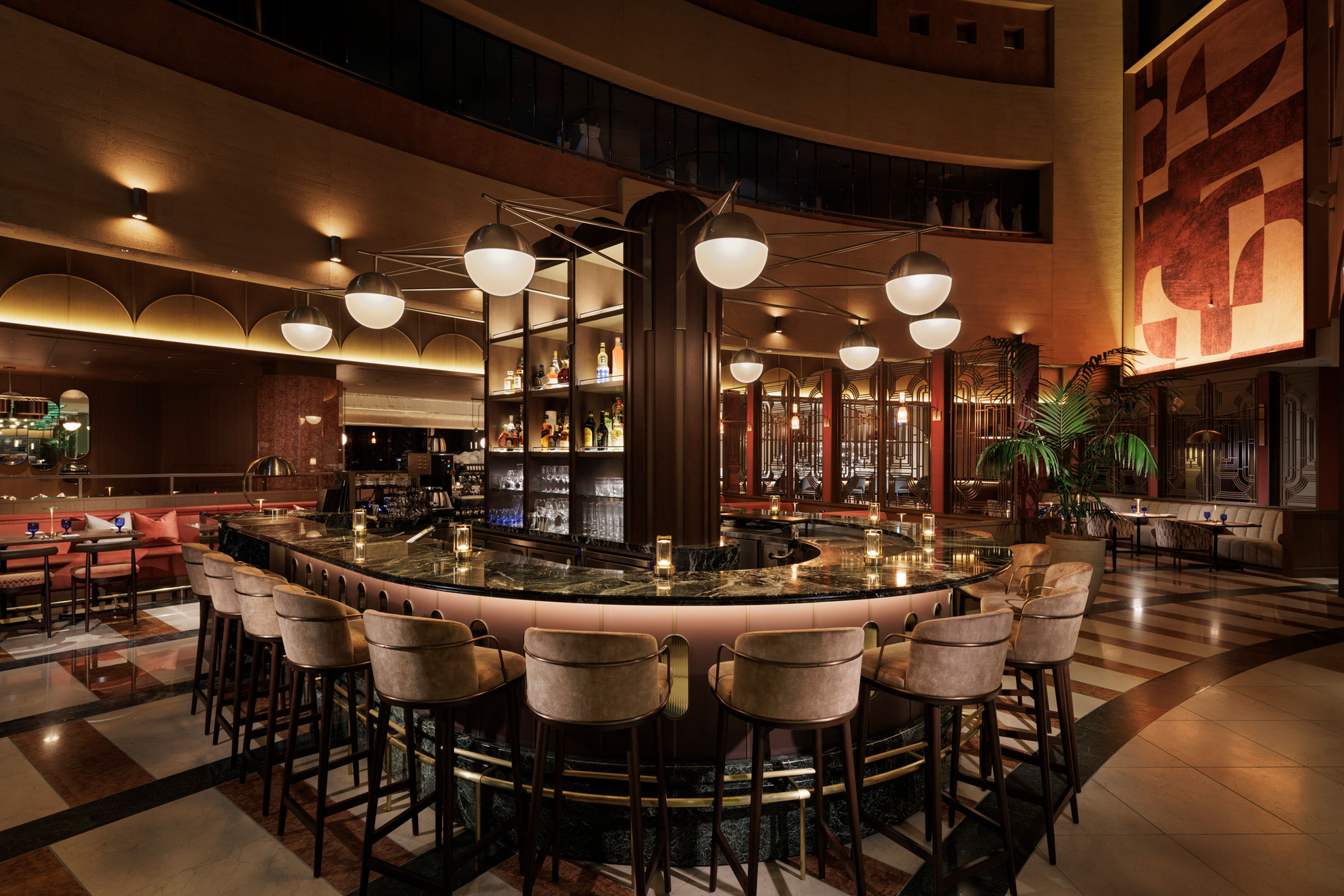 Elegant, dimly lit restaurant bar with a central curved counter, plush stools, glowing pendant lights, and bottles displayed on shelves, exuding a warm, inviting atmosphere.