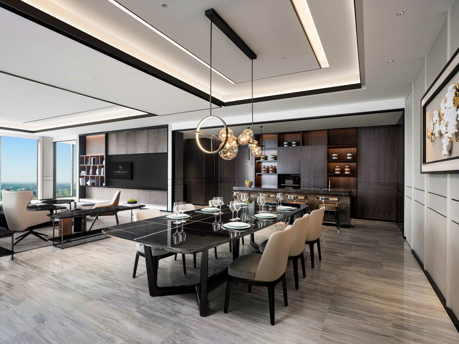 Modern dining room with a sleek black table set for six, plush chairs, and a chic chandelier. Open layout with wooden accents and warm lighting.