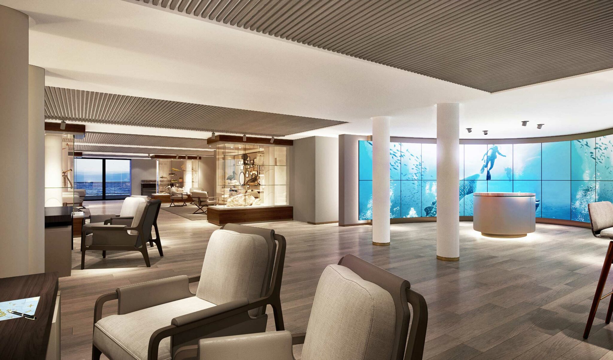 Luxurious modern cruise lounge with soft beige chairs, wooden flooring, and large digital screens displaying an underwater scene, creating a serene atmosphere.