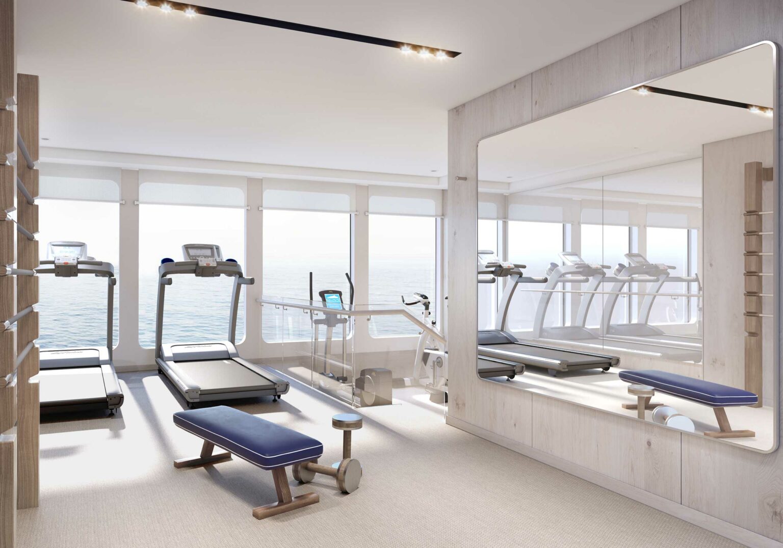 Bright, modern cruise gym with treadmills, a stationary bike, and benches facing large windows overlooking the ocean. Mirrors enhance the spacious feel.