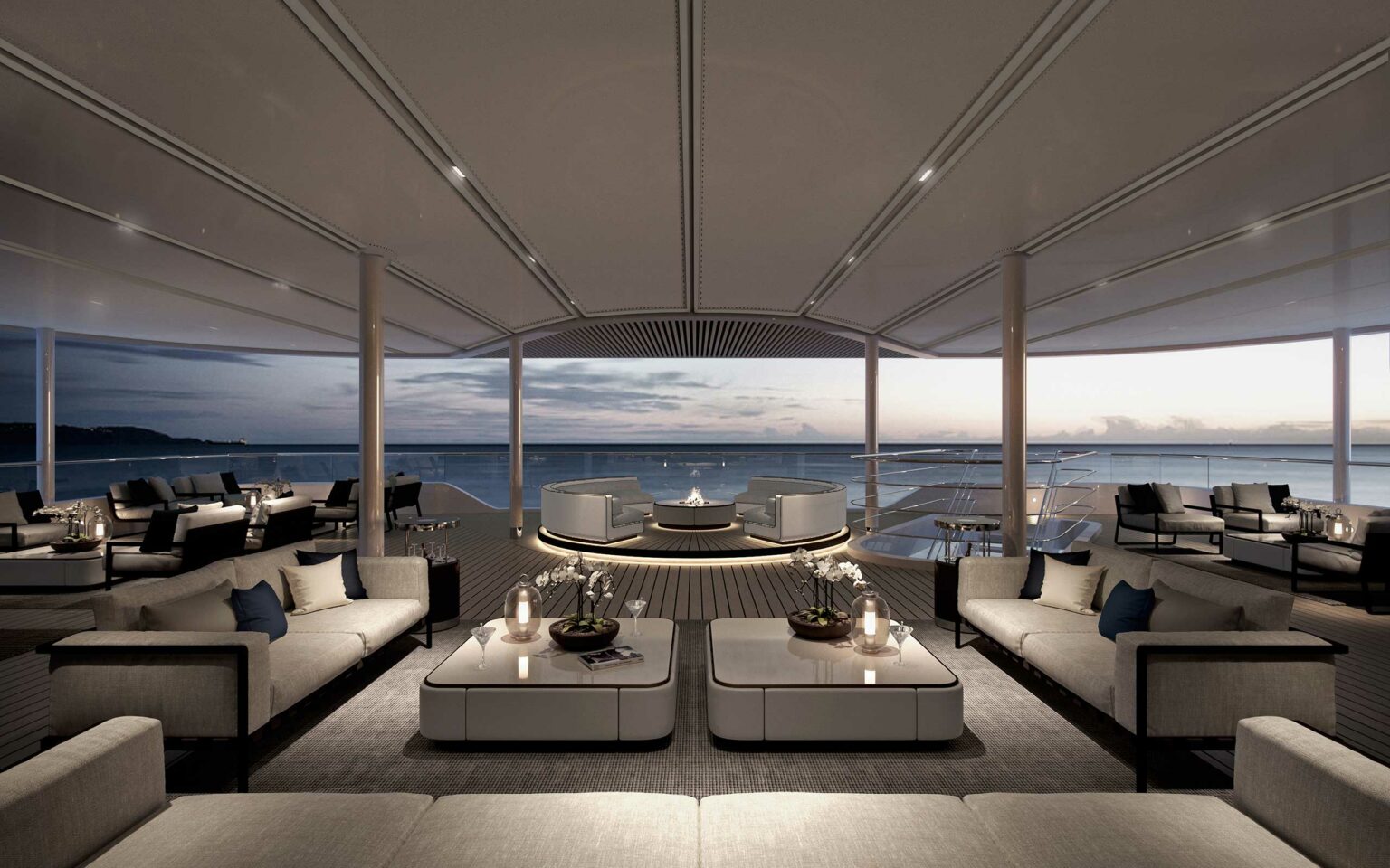A luxurious, contemporary cruise deck looking out to sweeping ocean views.