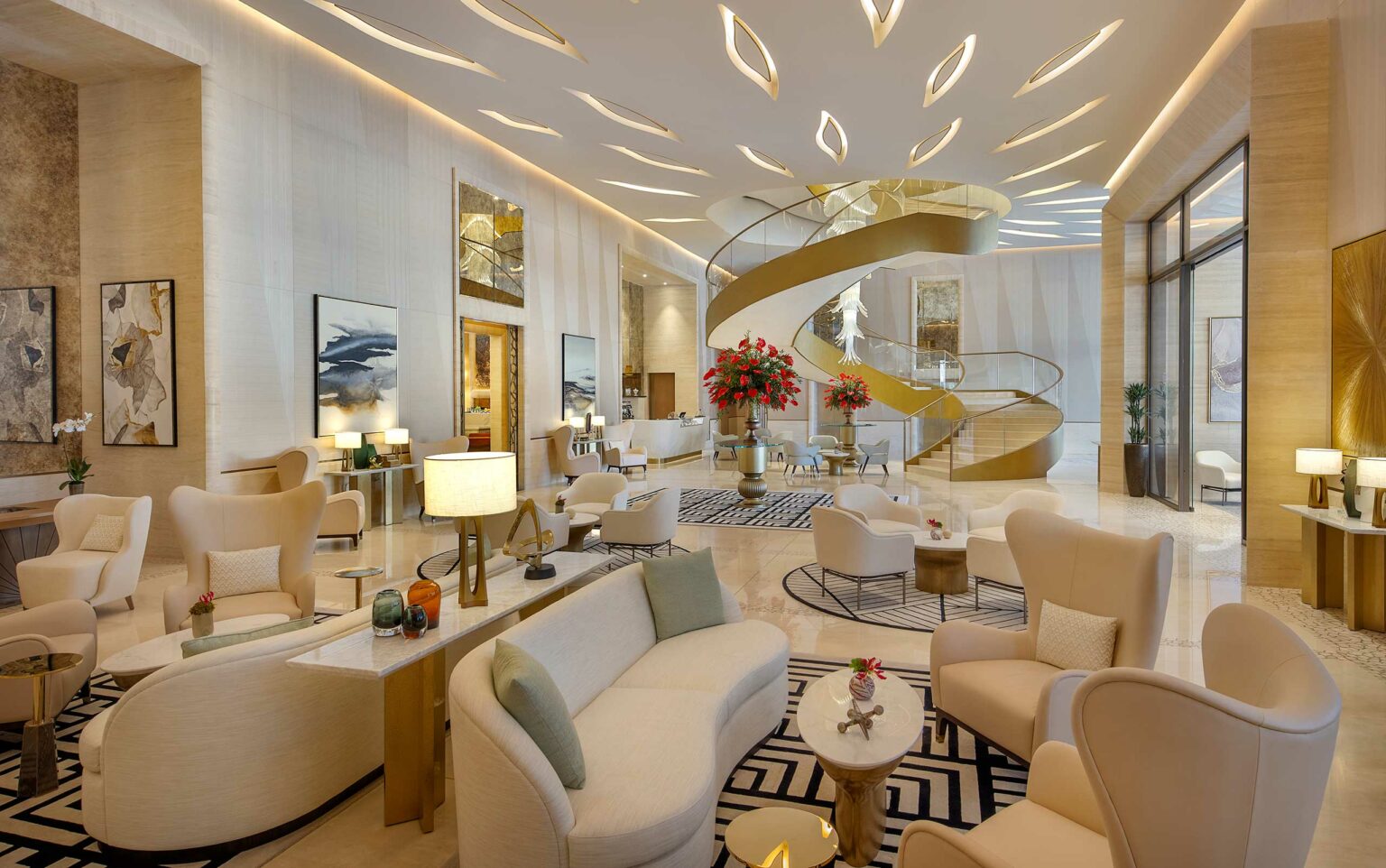 Luxurious hotel lobby with a grand spiral staircase, elegant seating, abstract art, and soft lighting. Modern, spacious, and inviting atmosphere.
