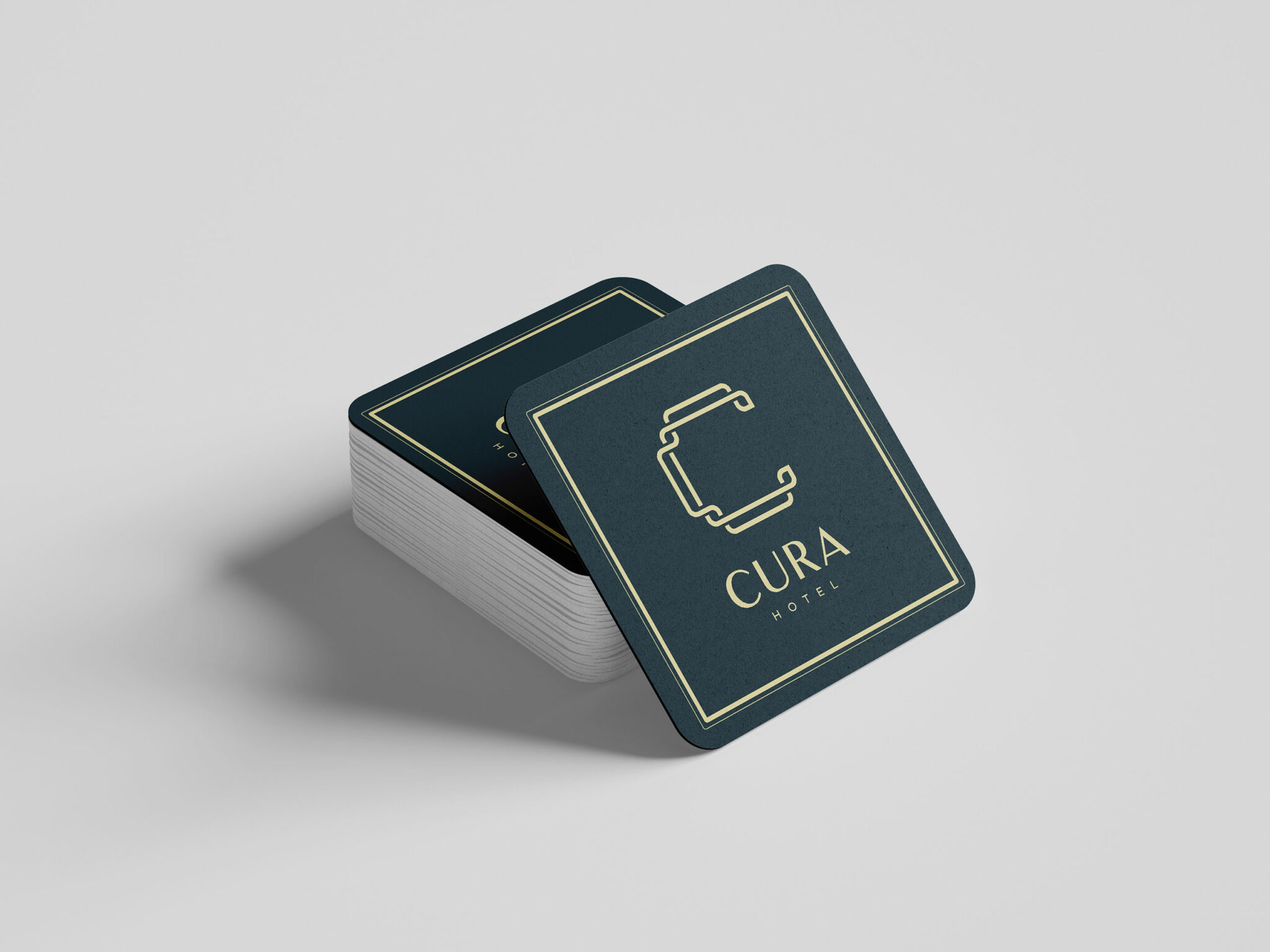 A stack of elegant navy coasters with gold trim and logo for 