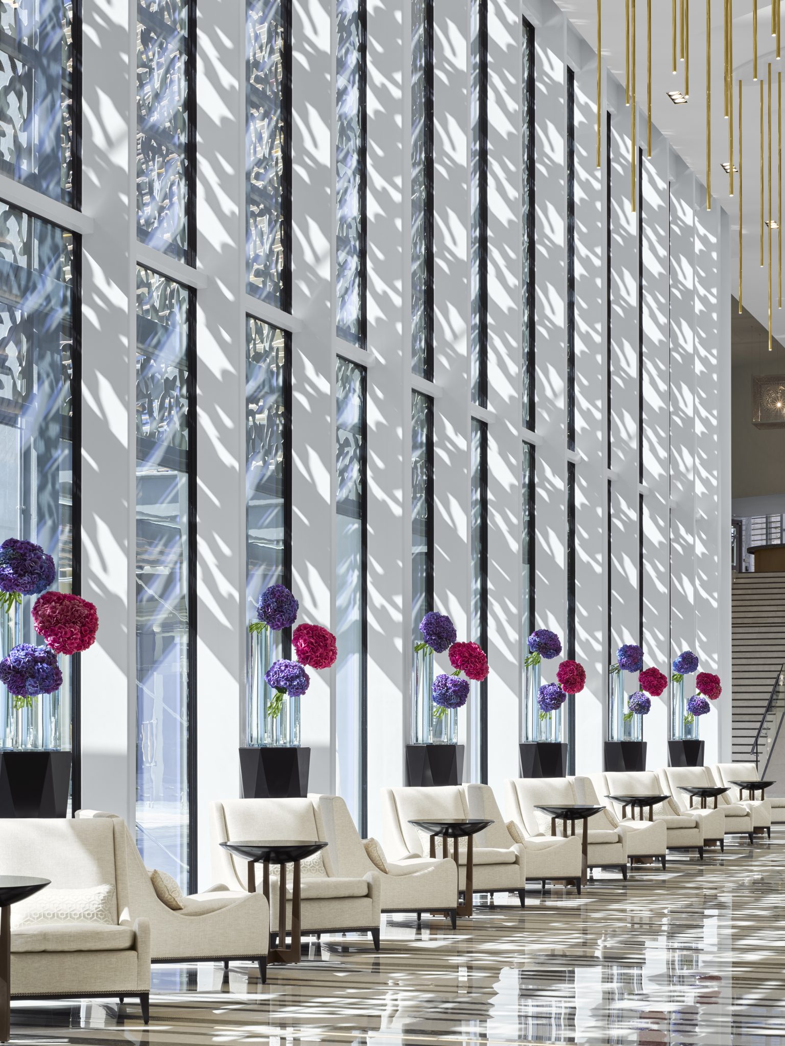 A ultra-luxury hotel lobby with floor to ceiling windows.