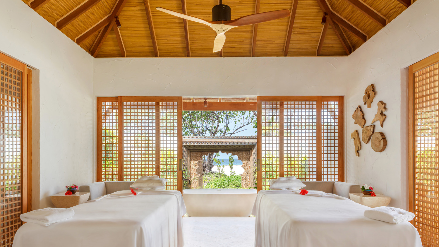 A tranquil, seaside inspired spa treatment room with traditional Maldivian accents.