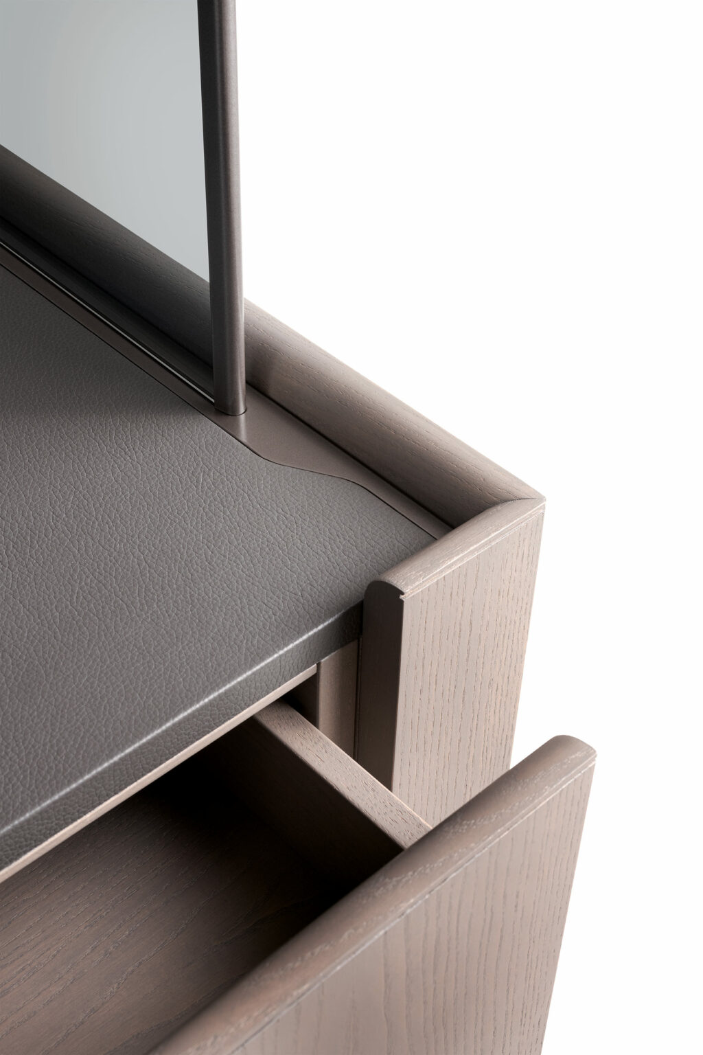 Close-up of a modern brown cabinet, featuring a sleek, minimalist wood and leather desk with an open drawer.