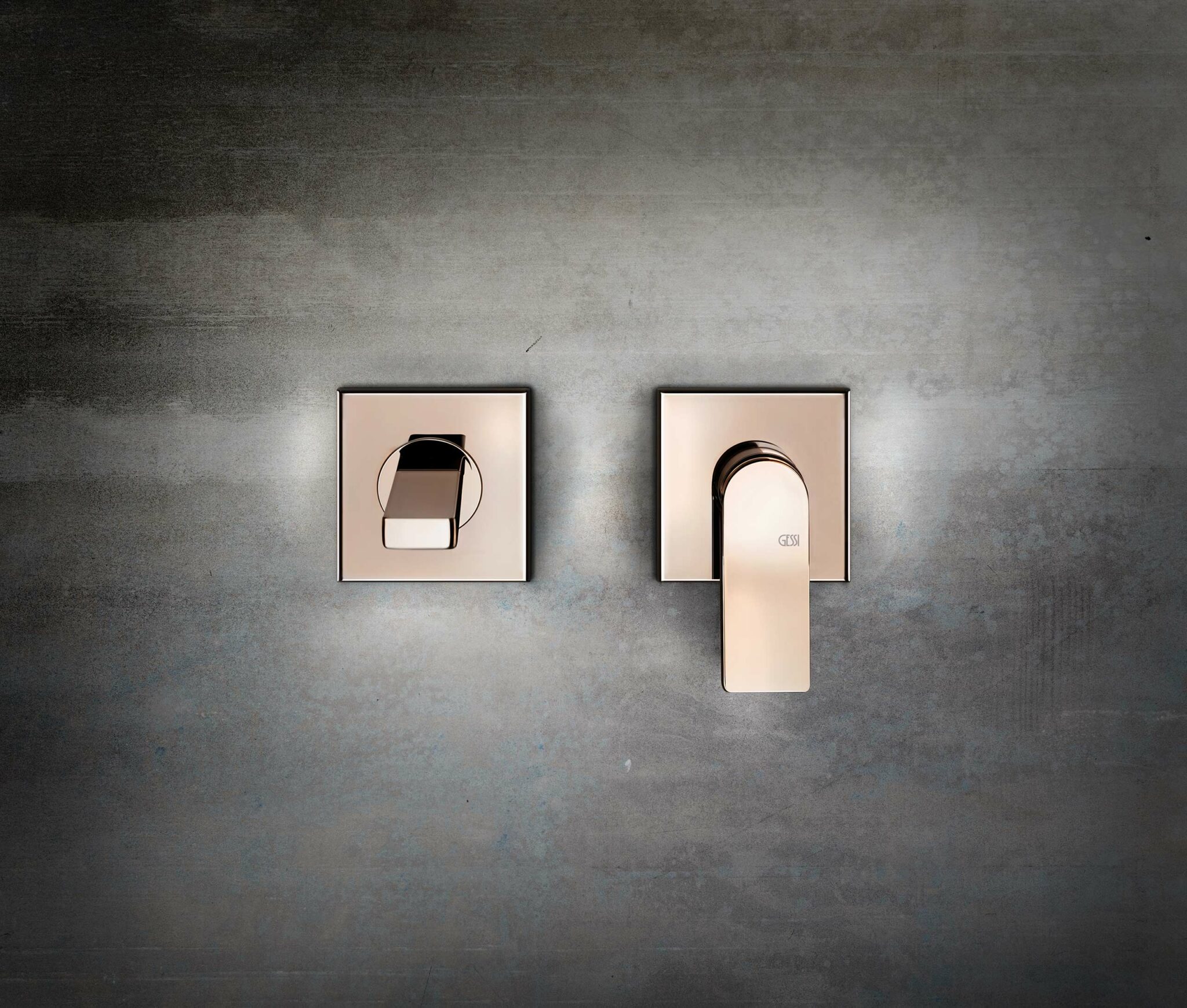 Sleek rose gold wall-mounted faucets with modern, minimalist design against a gray background, conveying elegance and luxury.