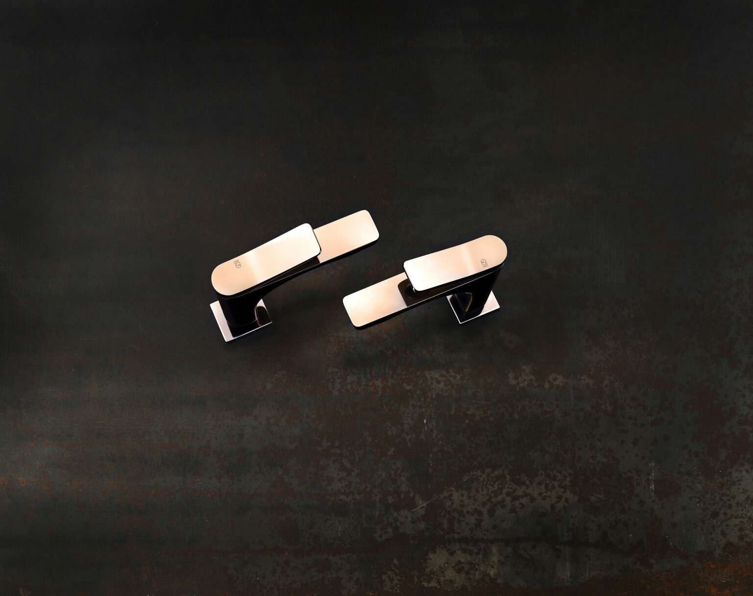 Overview of sleek chrome faucets on a dark background. Their reflective surfaces create a modern and elegant appearance, conveying sophistication and style.